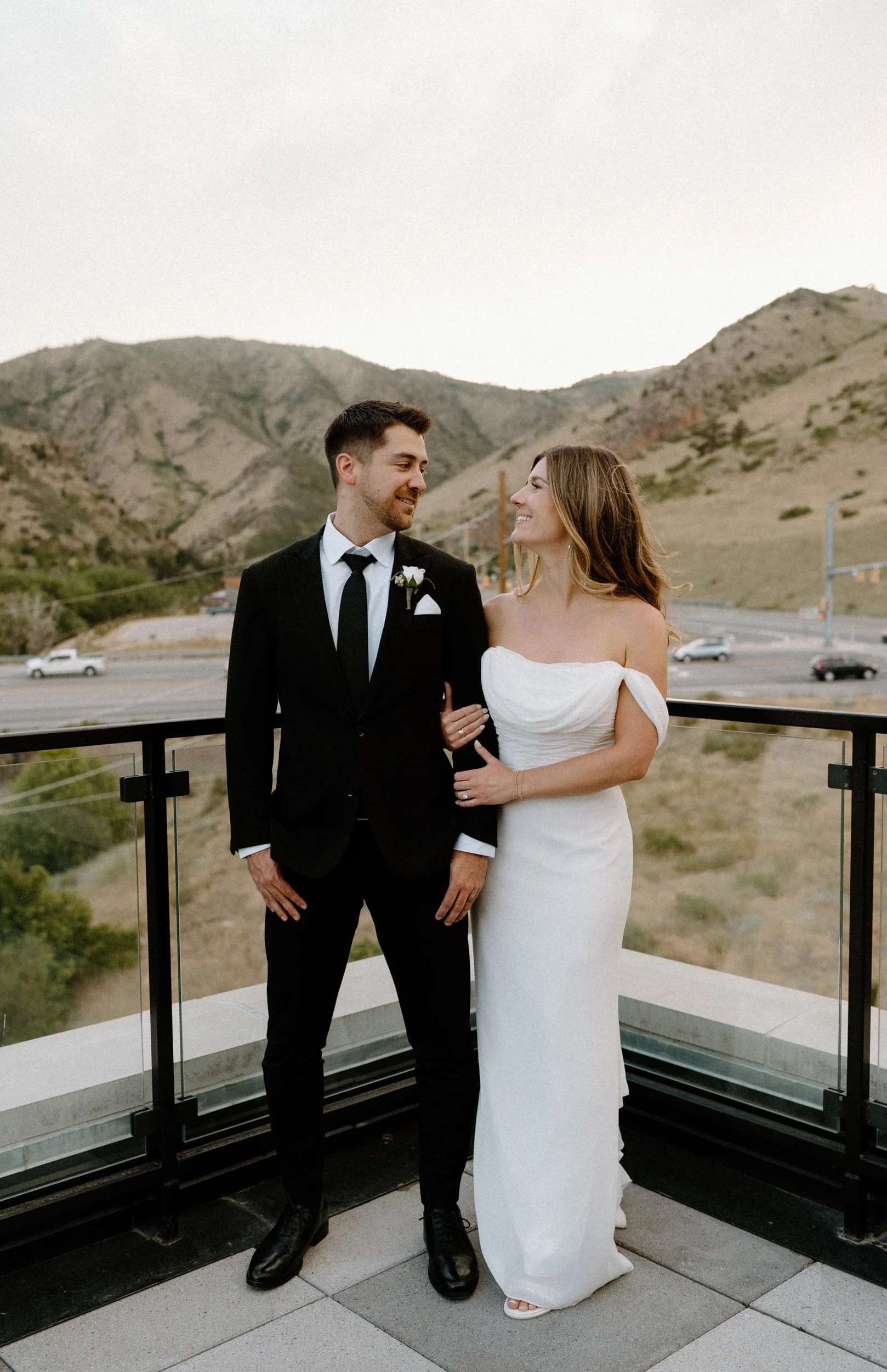 Bride and groom looking at each other and smiling on wedding day in Golden Colorado at The Eddy Hotel