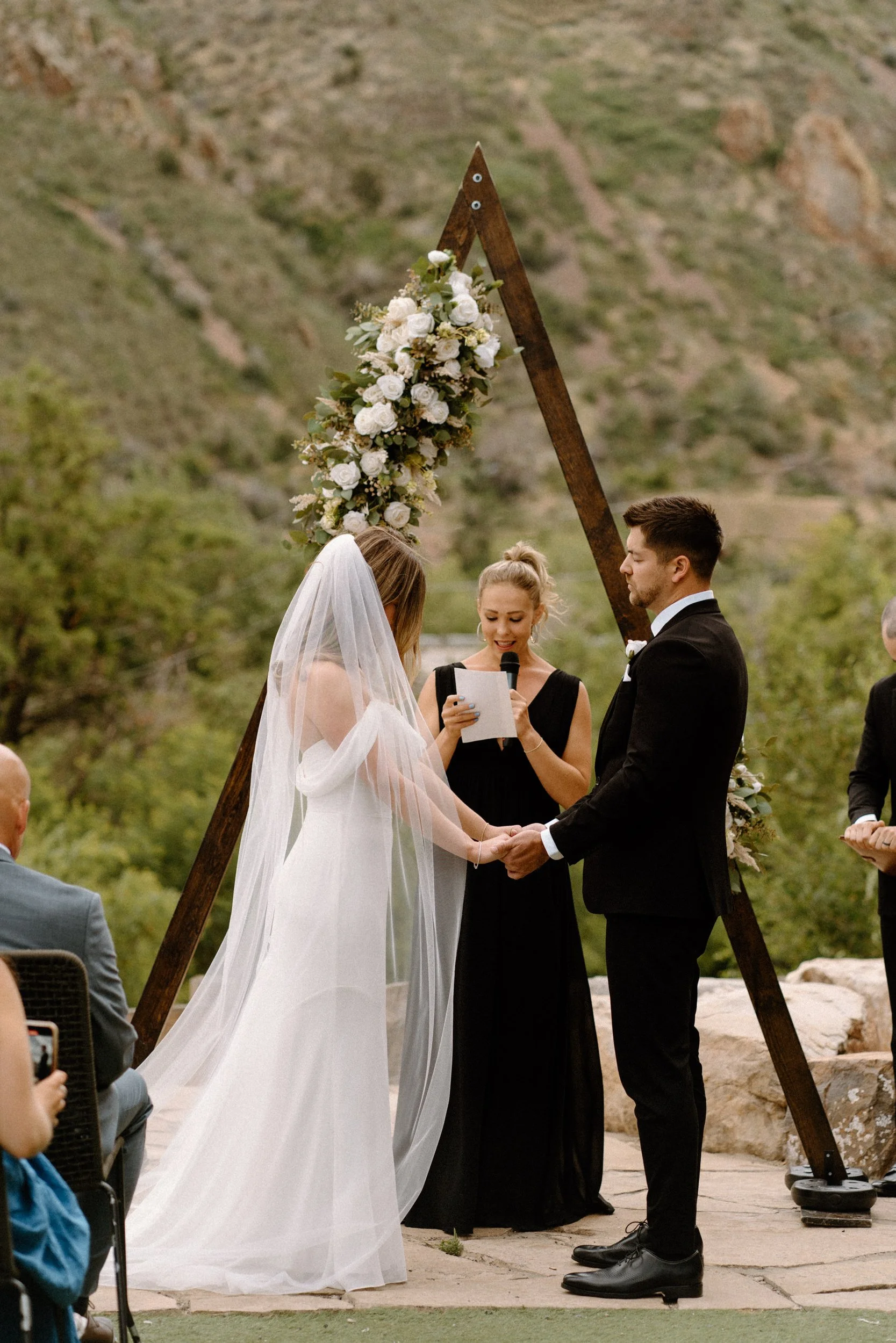 Bride and groom holding hands at the alter during wedding day at The Eddy in Golden Colorado