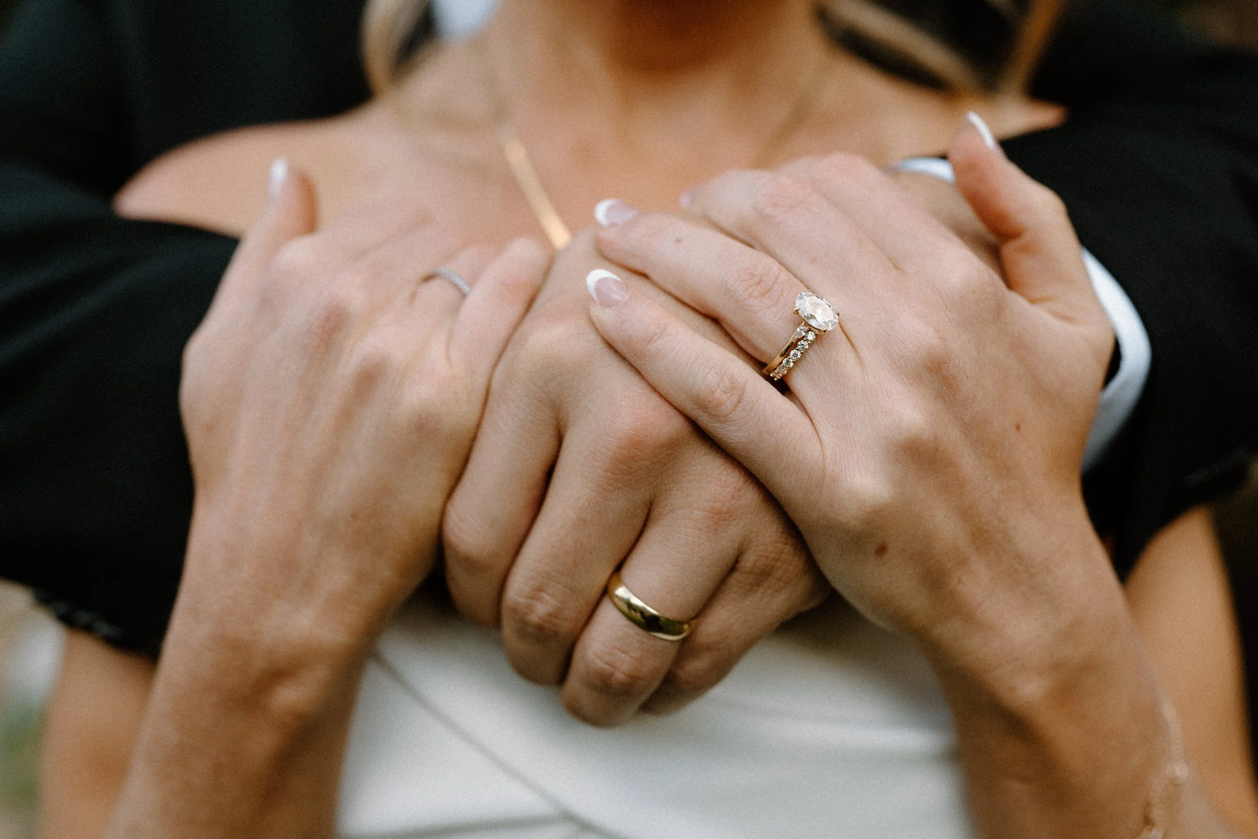 Bride and groom hugging showing wedding rings at Blackstone Rivers Ranch
