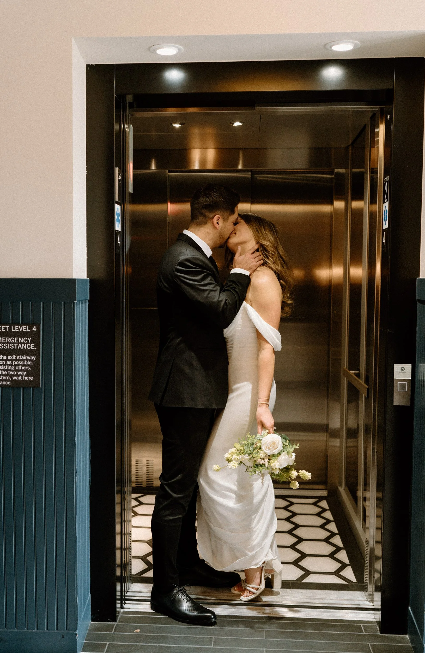 Bride and groom kissing in an elevator at The Eddy in Golden Colorado on wedding day
