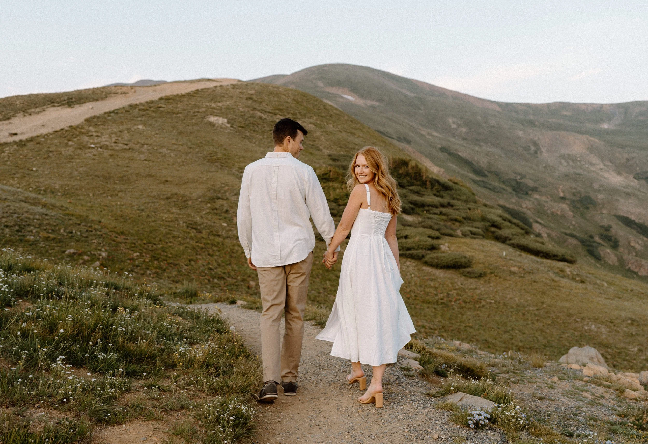 Couple hiking on a trail during an engagement photoshoot at Loveland Pass