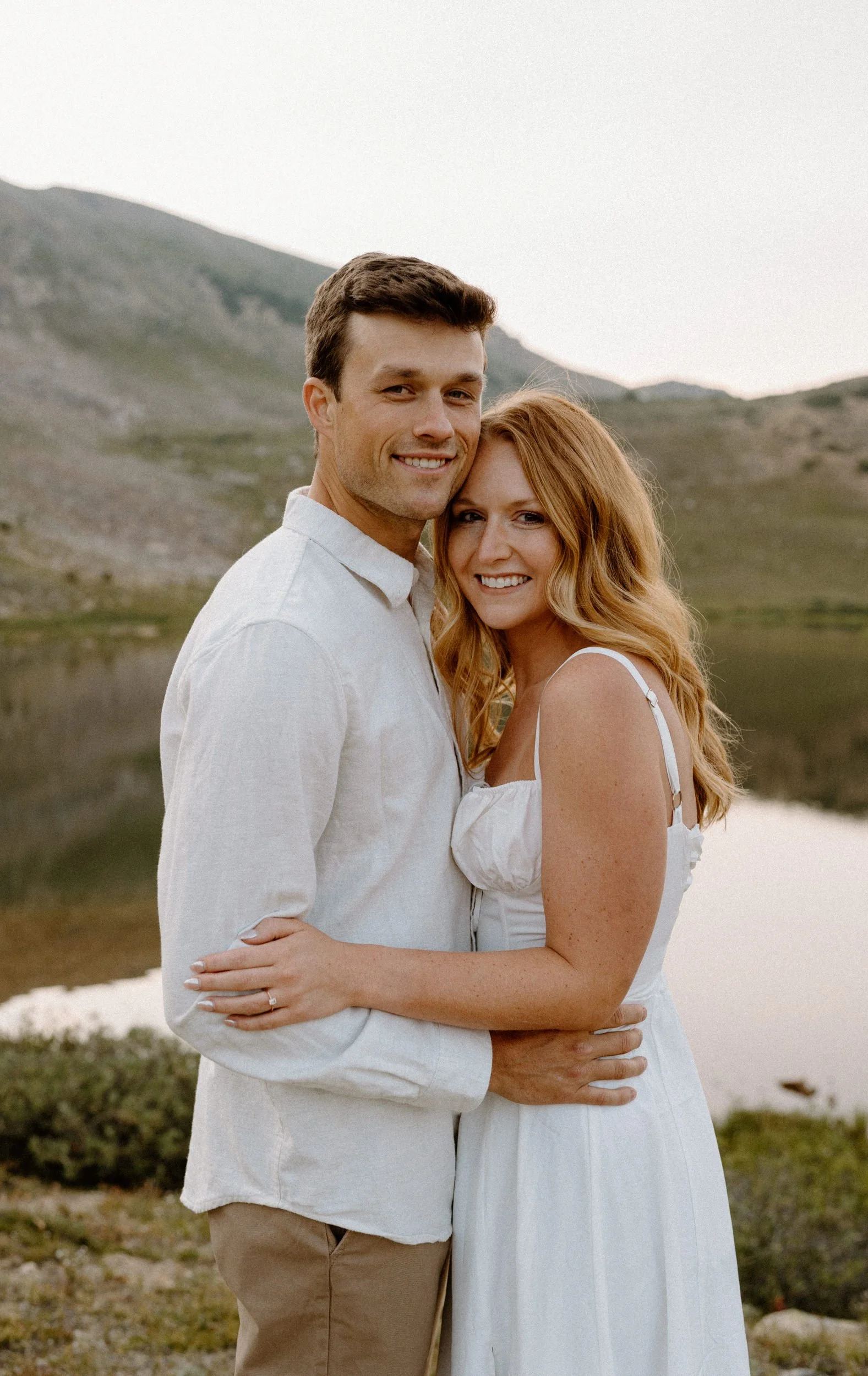 Couple smiling at the camera during an engagement session at Loveland Pass