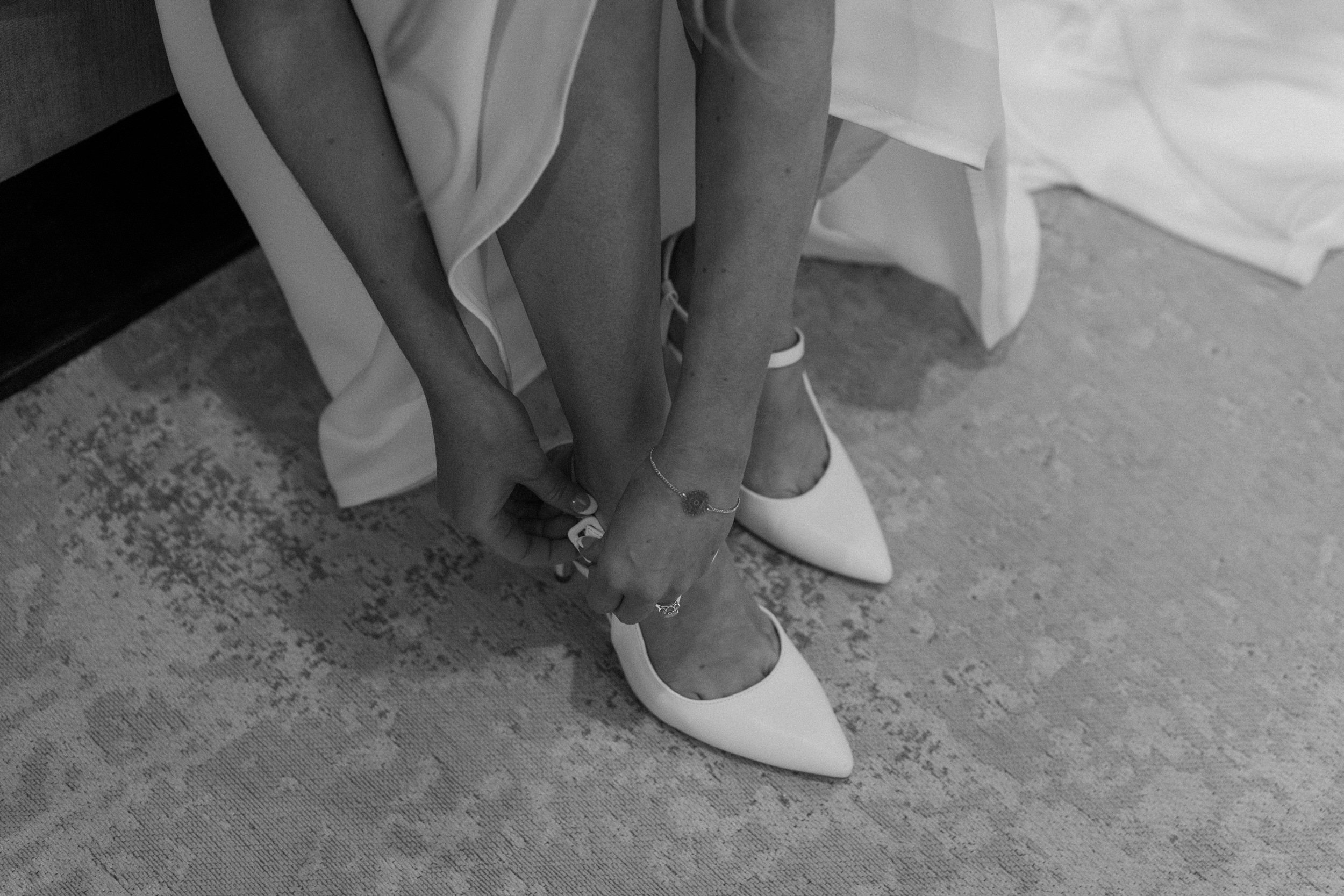 Bride putting on heels on wedding day at Blackstone Rivers Ranch