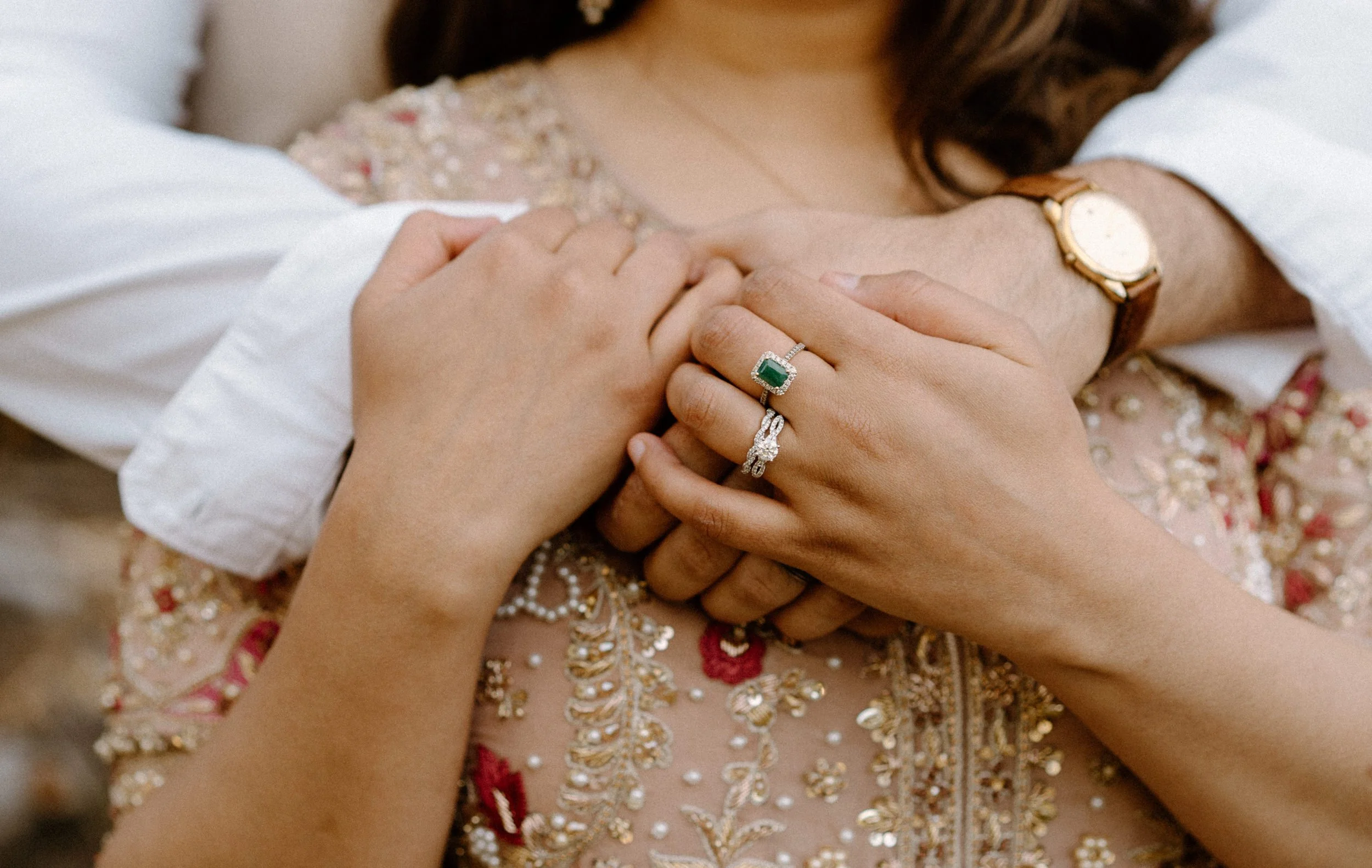 Couple hugging over shoulder showing engagement ring in Boulder Colorado