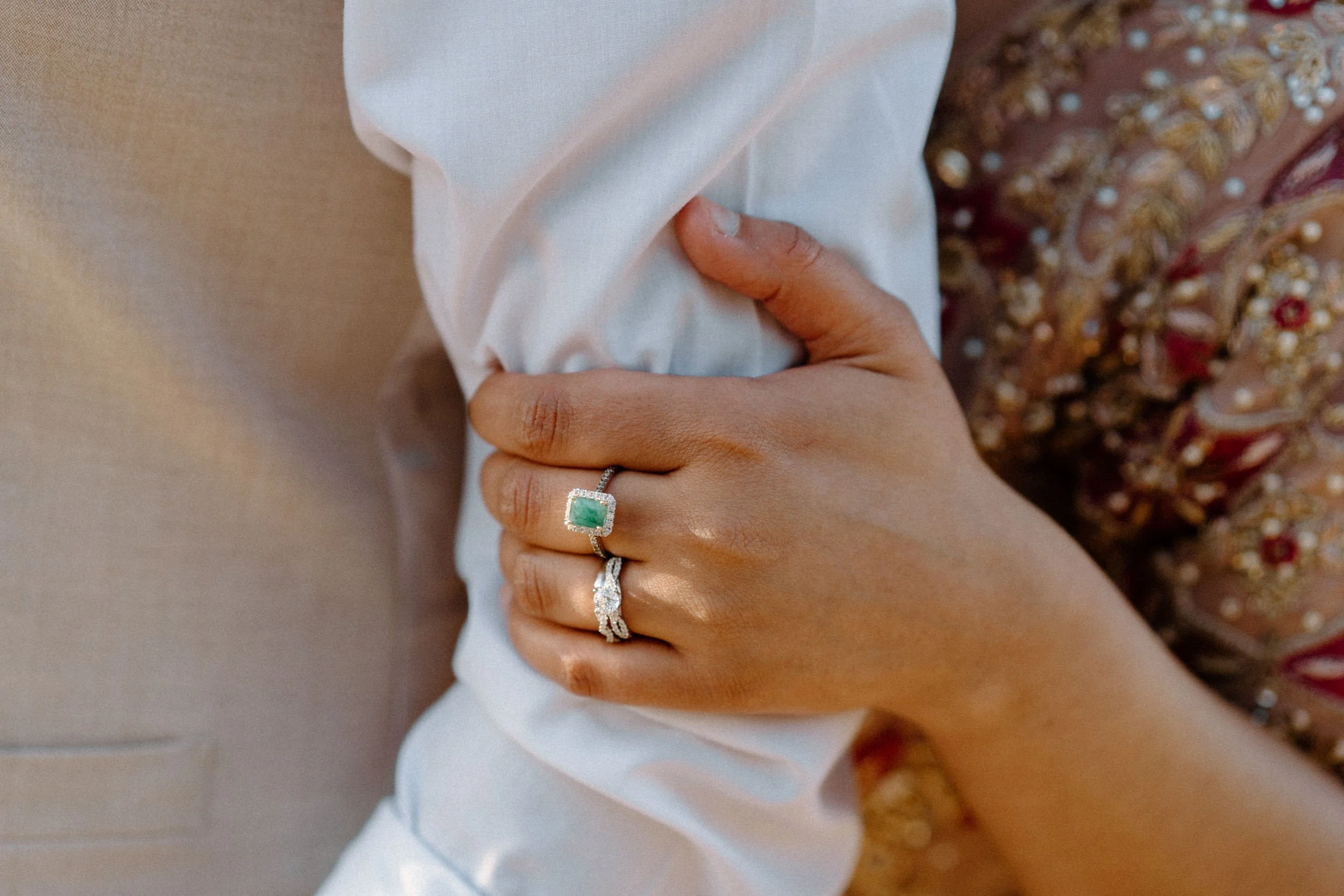 Fiancée holding fiancée's arm showing engagement ring during an engagement session in Boulder Colorado