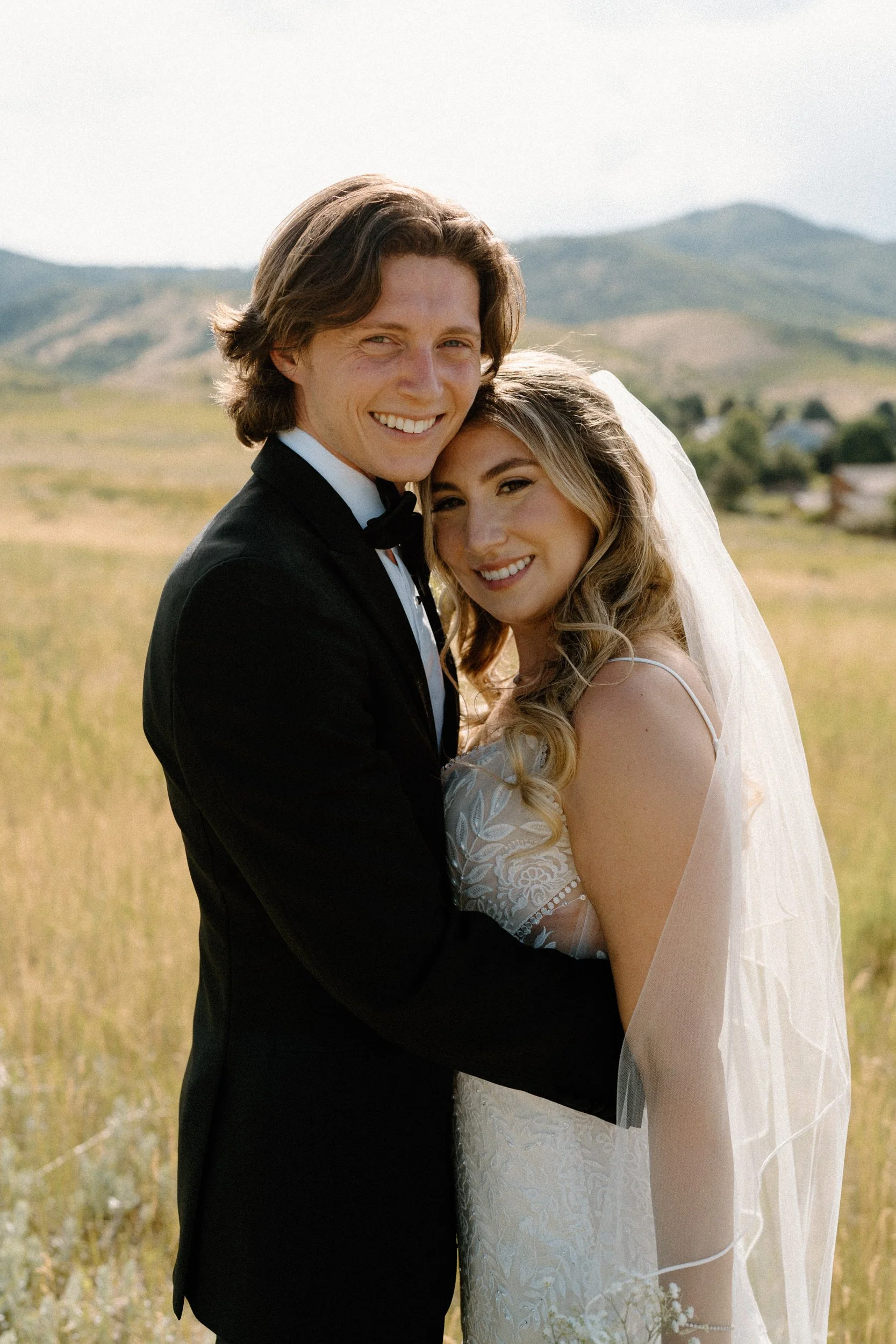 Bride and groom smiling at the camera on wedding day at The Manor House