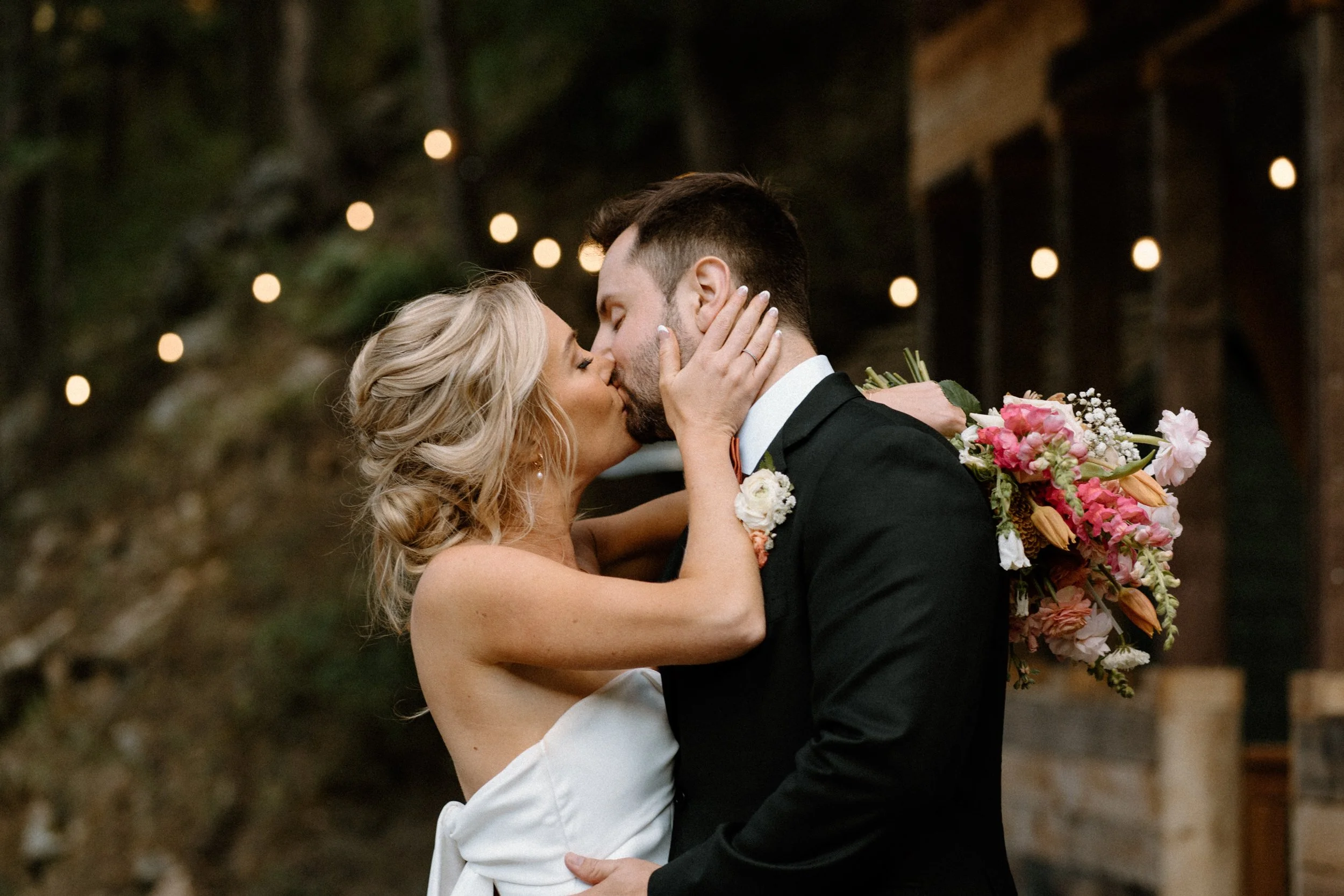 Bride and groom kissing at Blackstone Rivers Ranch on wedding day