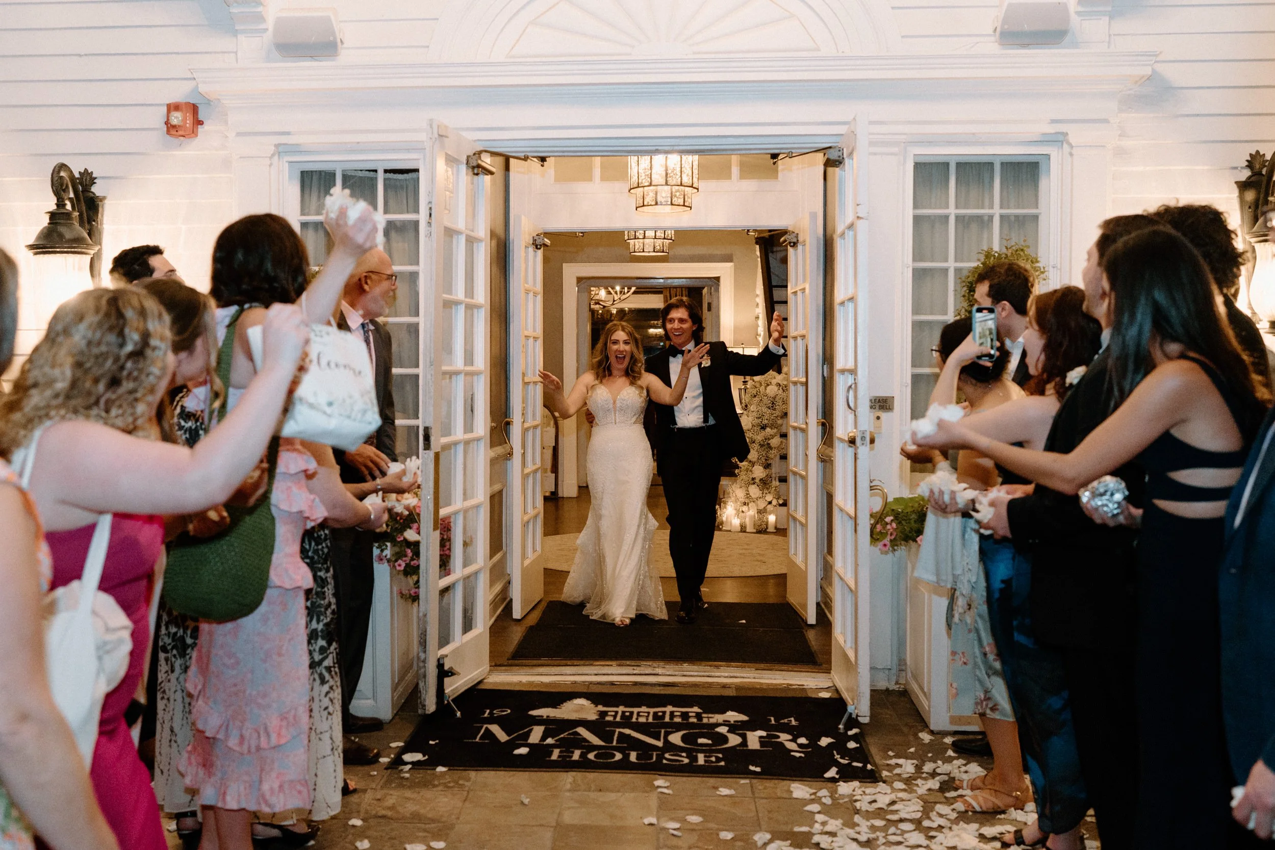 Bride and groom leaving their wedding at The Manor House