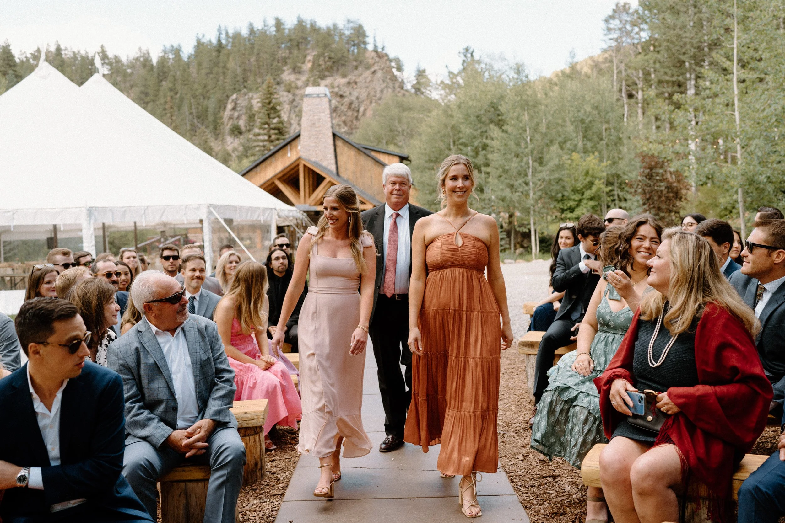 Bridesmaids walking down the aisle on wedding day at Blackstone Rivers Ranch