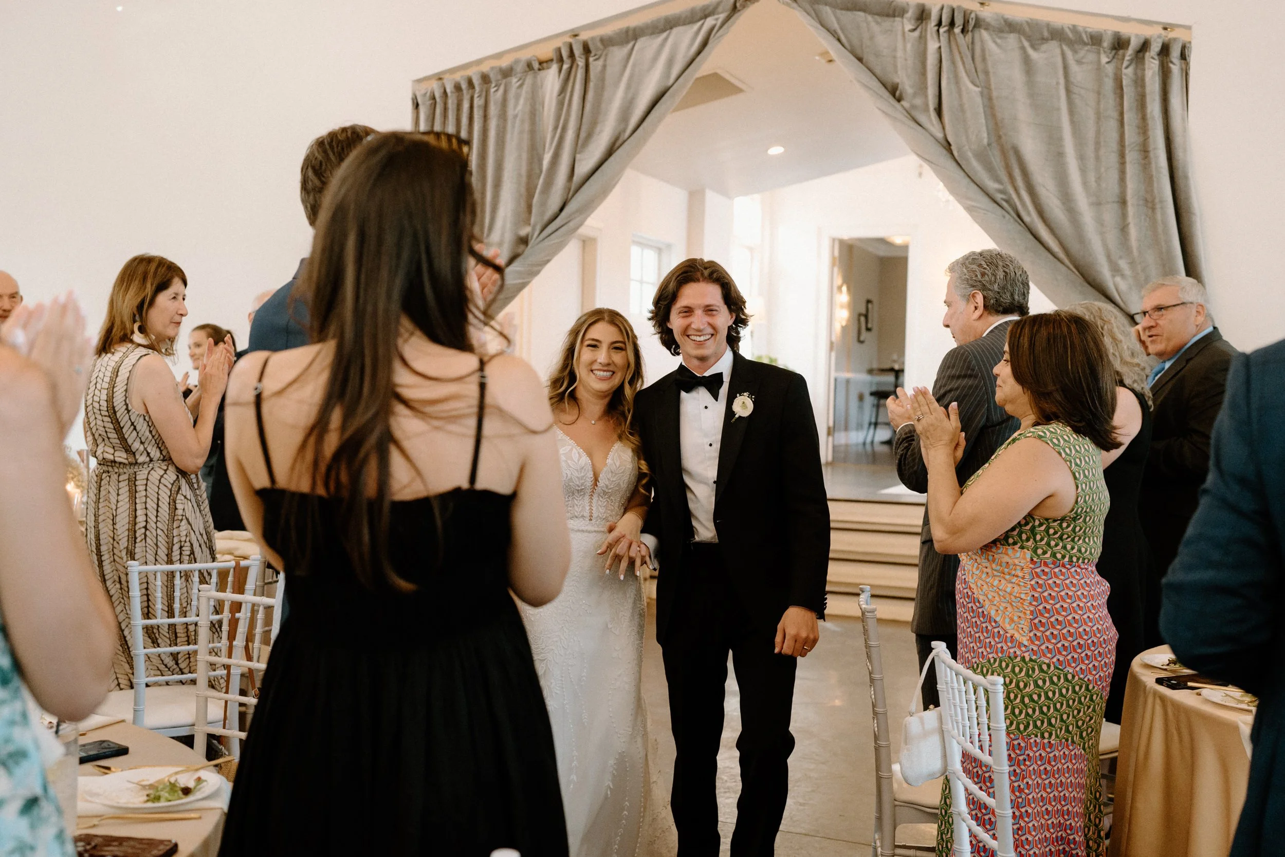 Bride and groom walking into reception on wedding day at The Manor House