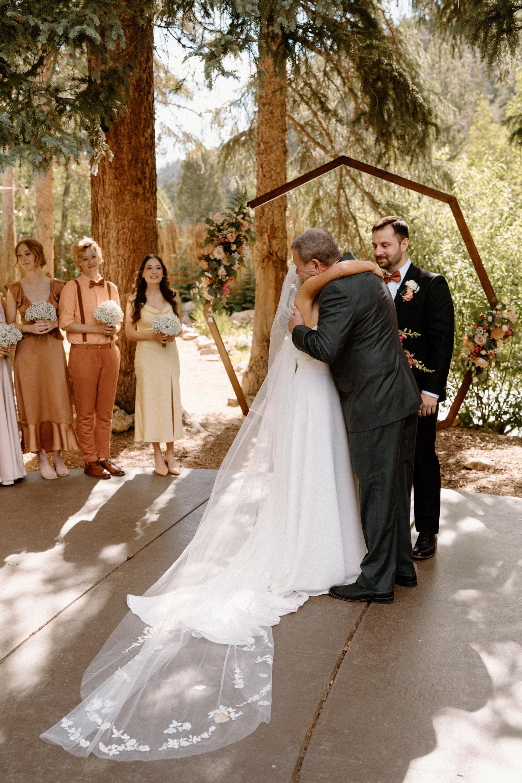 Bride hugging dad at the alter on wedding day at Blackstone Rivers Ranch