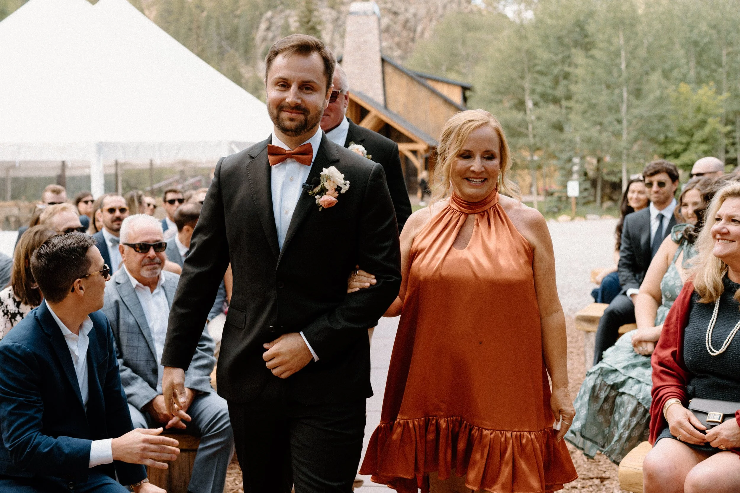 Groom and mom walking down the aisle on wedding day at Blackstone Rivers Ranch