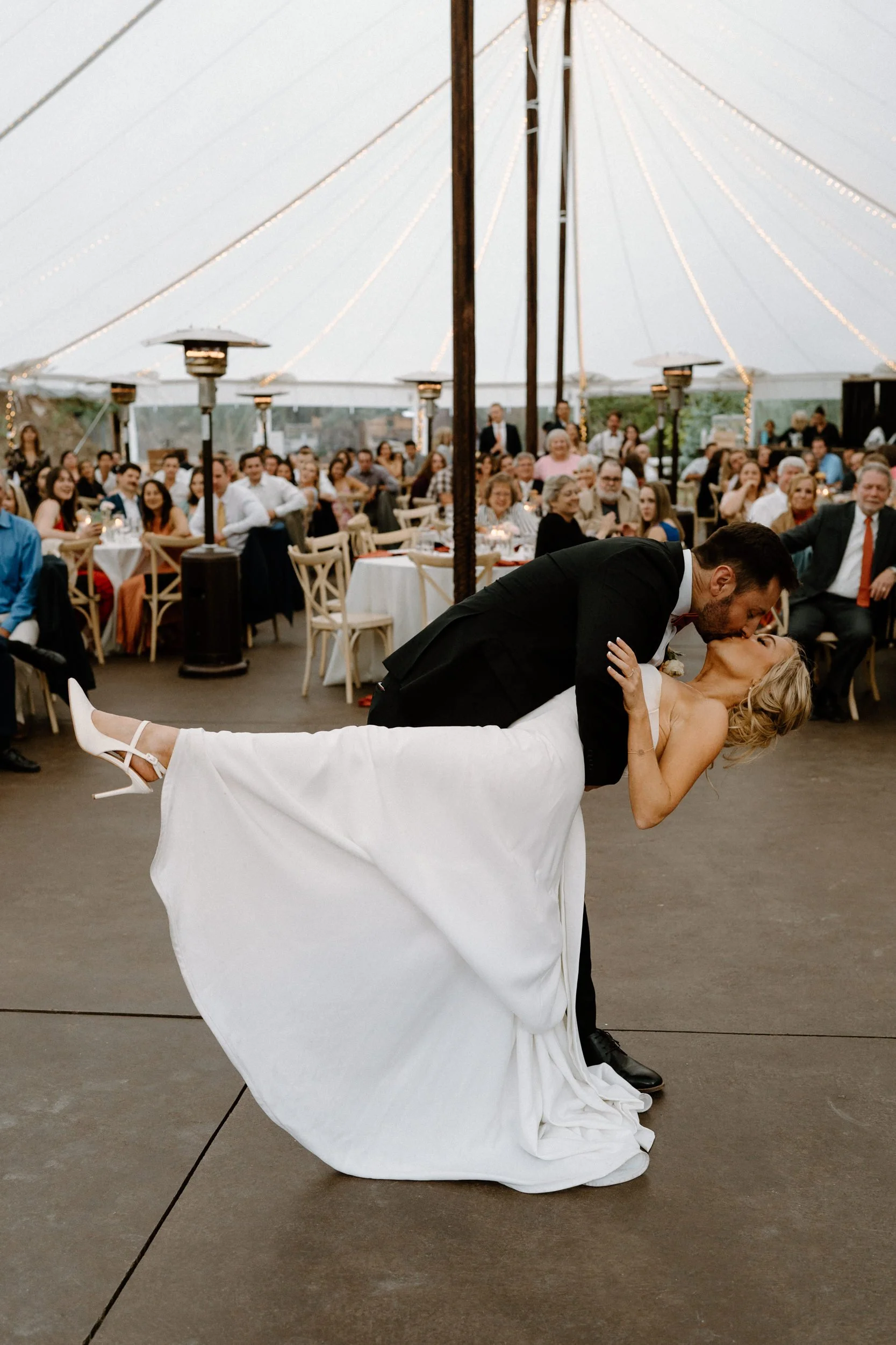 Groom dipping bride on dance floor at Blackstone Rivers Ranch
