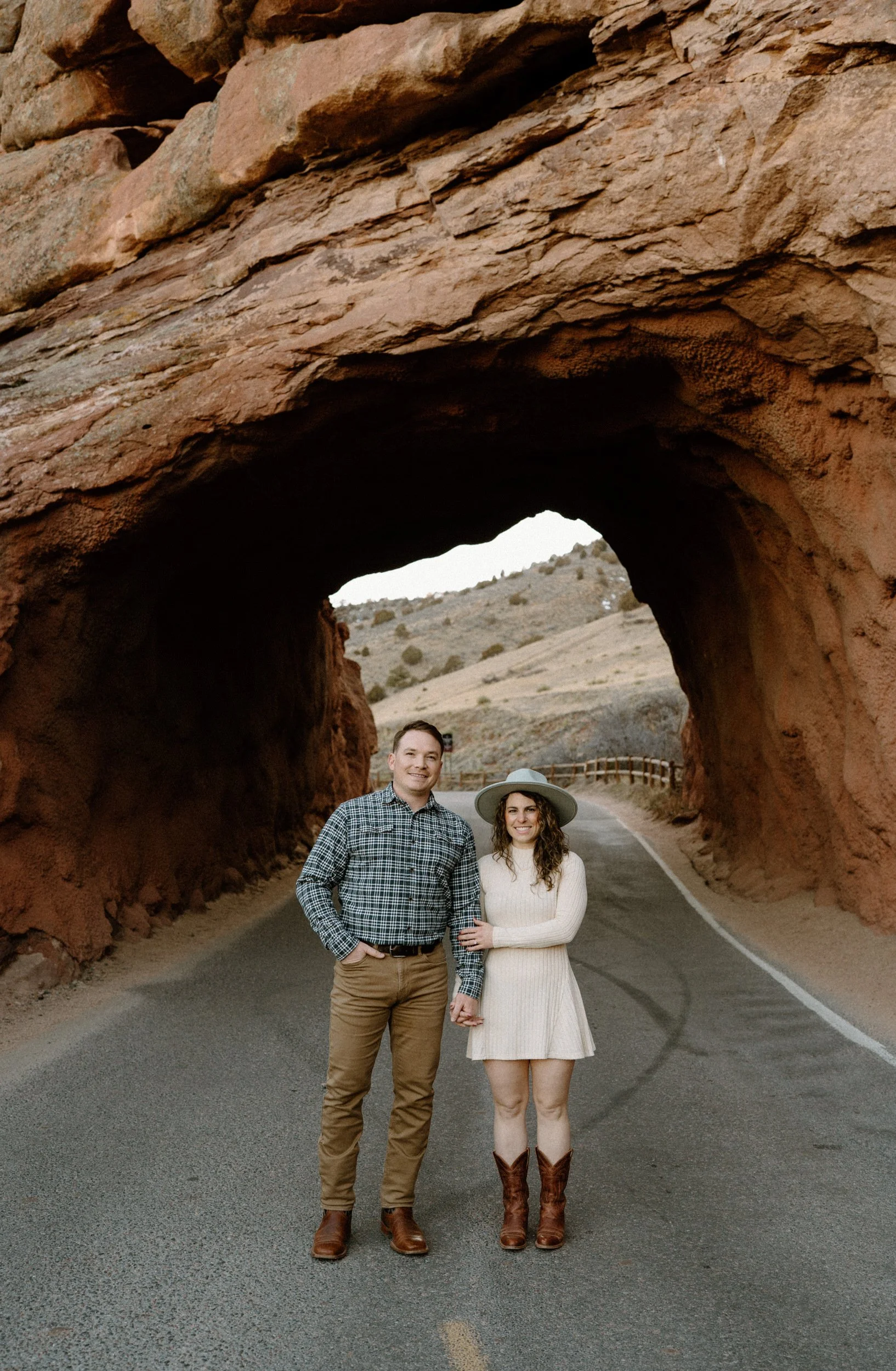 Couple smiling inside tunnel at Red Rocks during engagement session