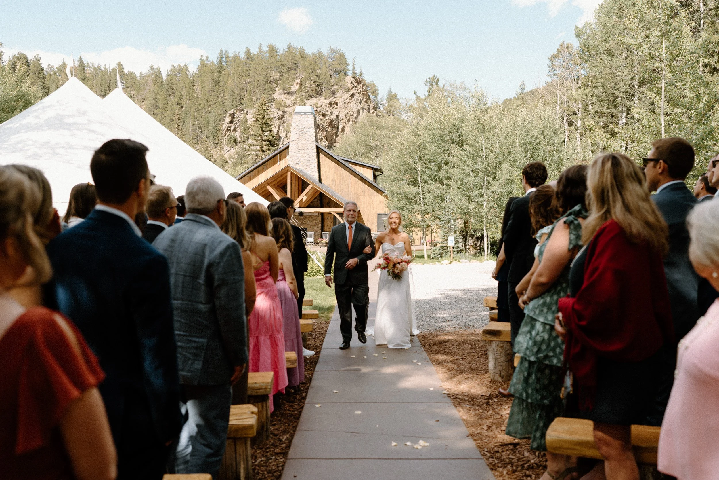Bride and her dad walking down the aisle at Blackstone Rivers Ranch on wedding day