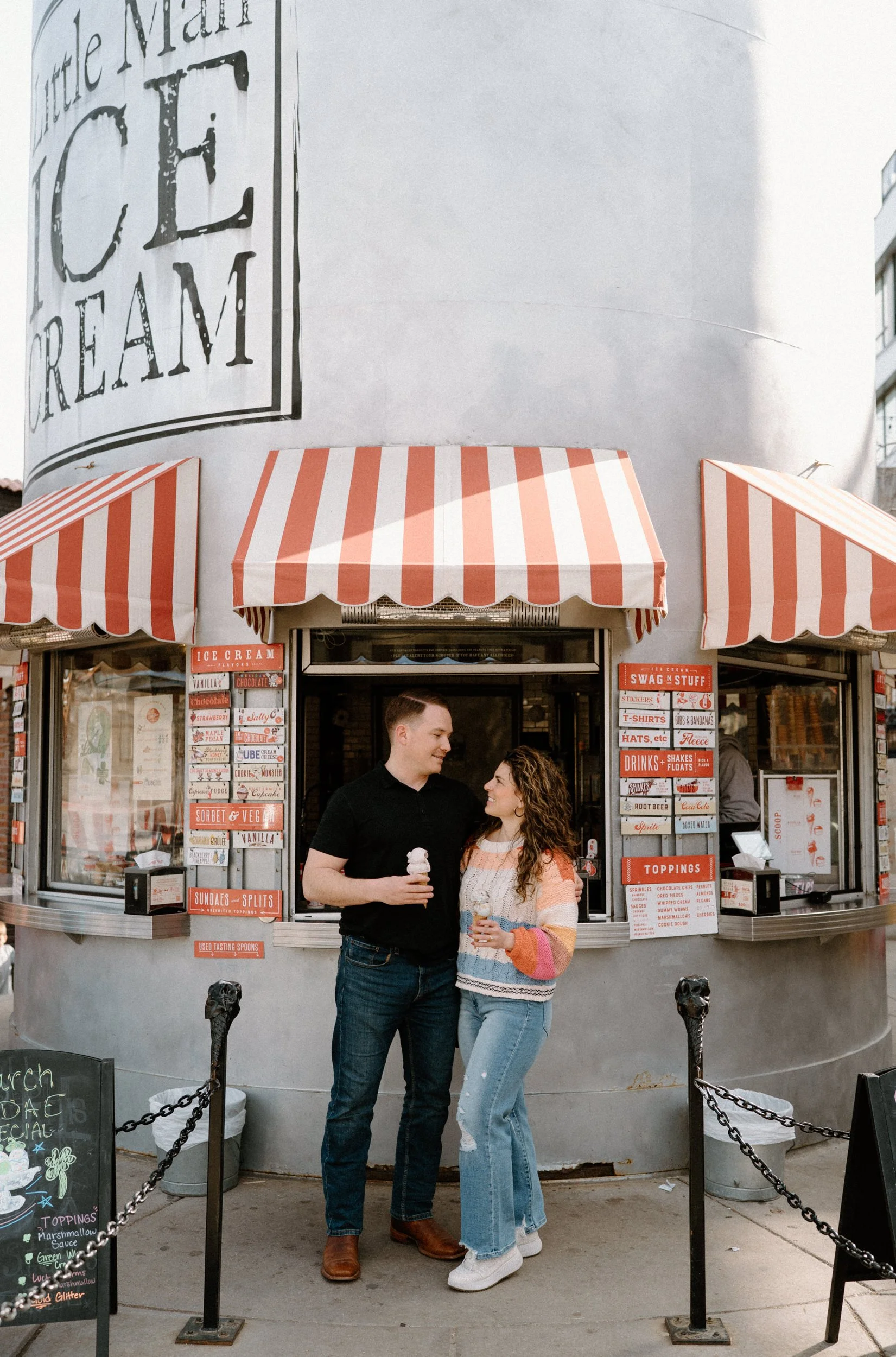 Couple looking at each other outside Little Man's ice cream during an engagement session