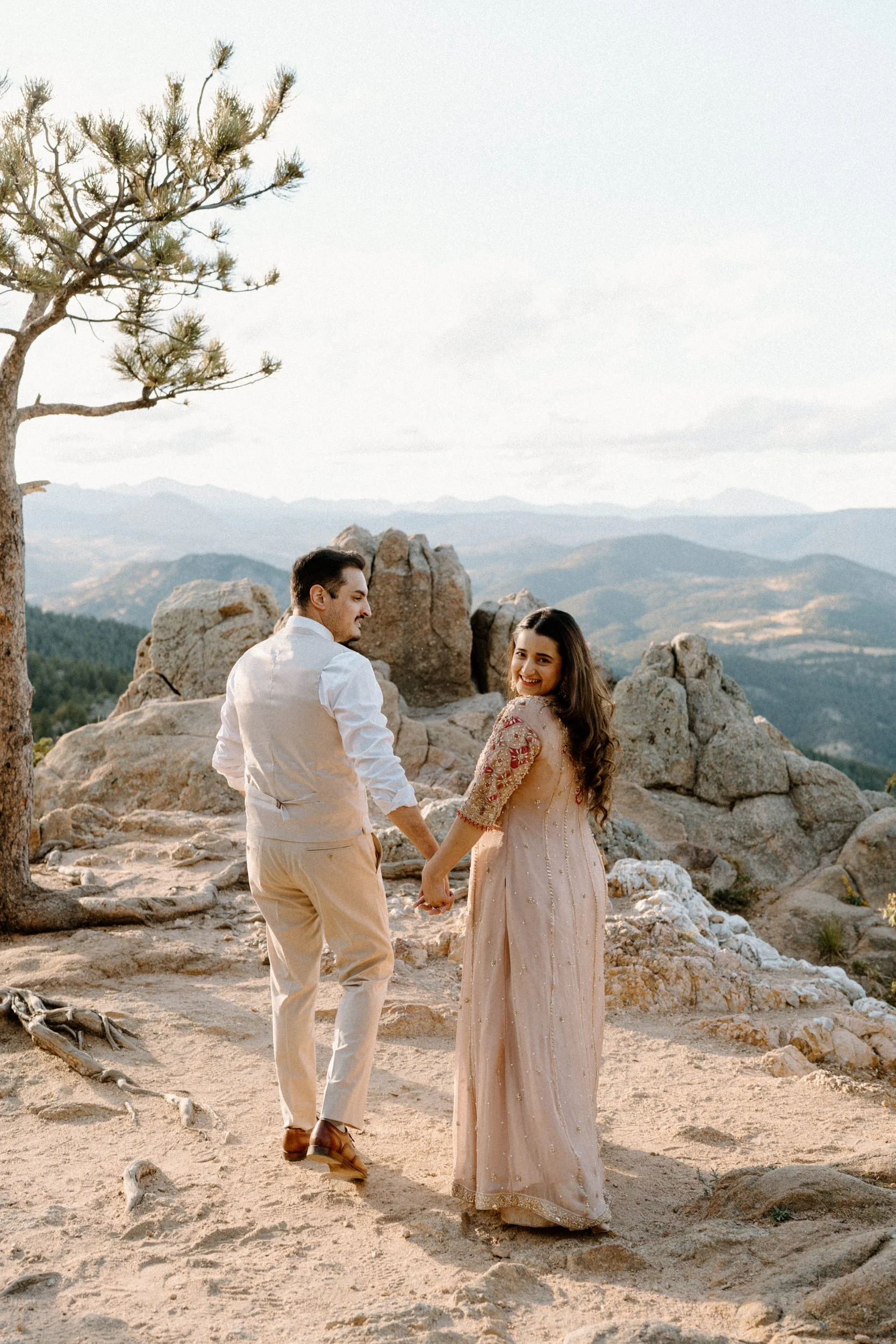 Couple walking on a mountain during an engagement session in Boulder Colorado