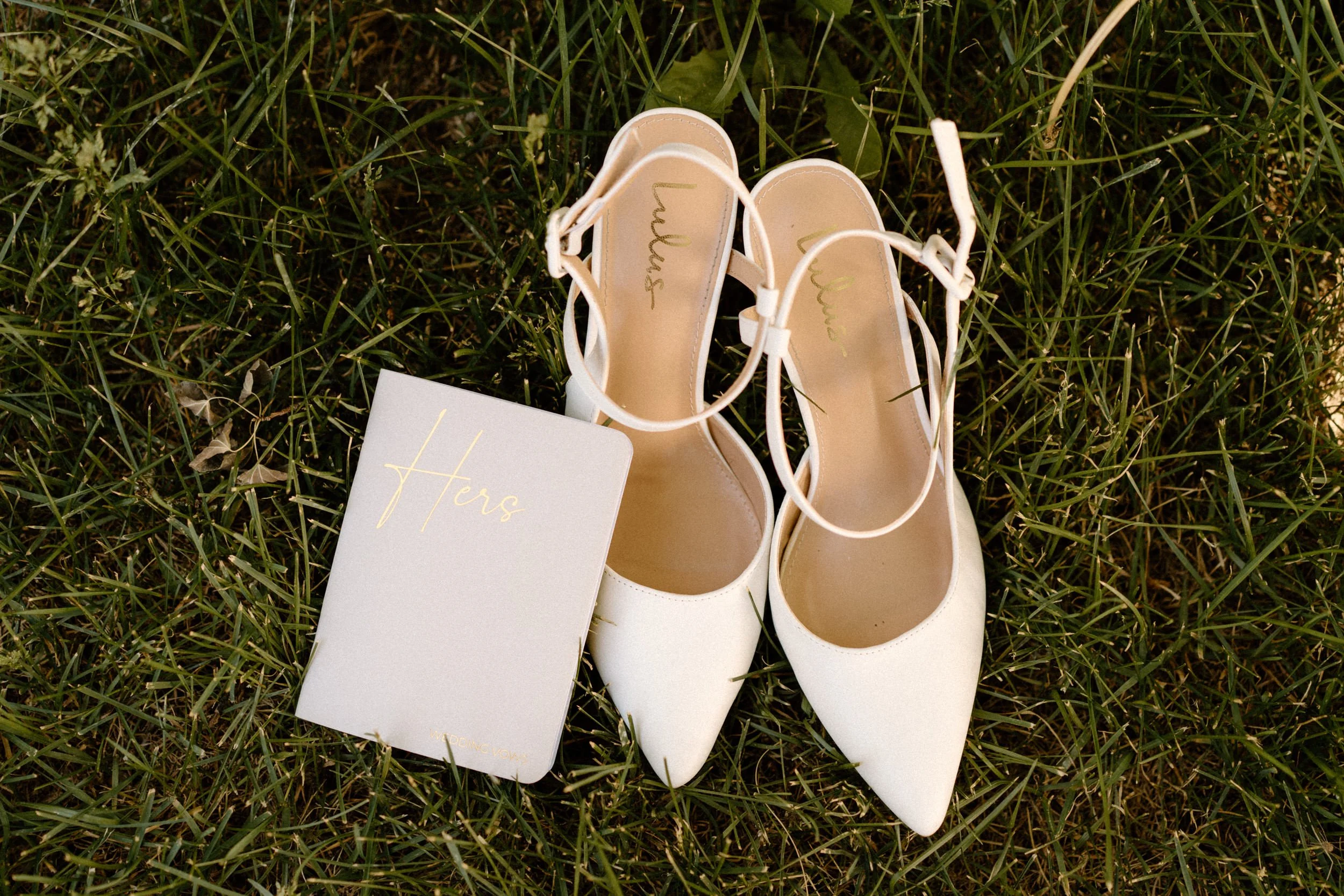Bride's wedding shoes and vow book from a wedding at Blackstone Rivers Ranch