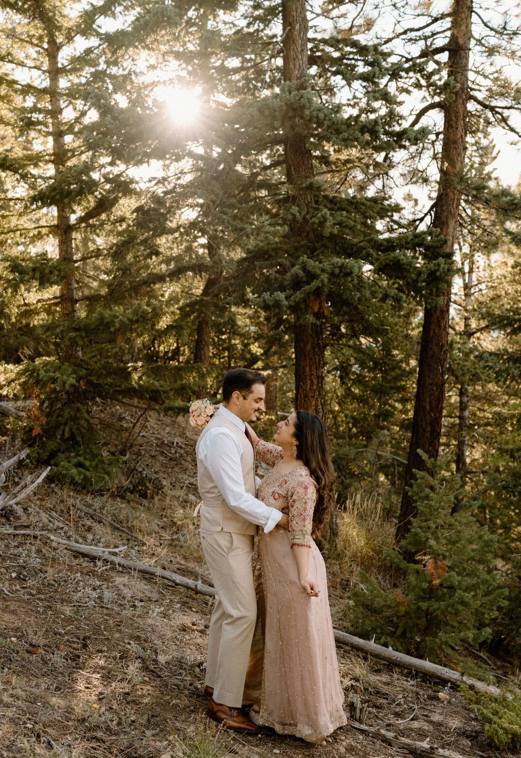 Couple hugging in the woods during an engagement session in Boulder Colorado