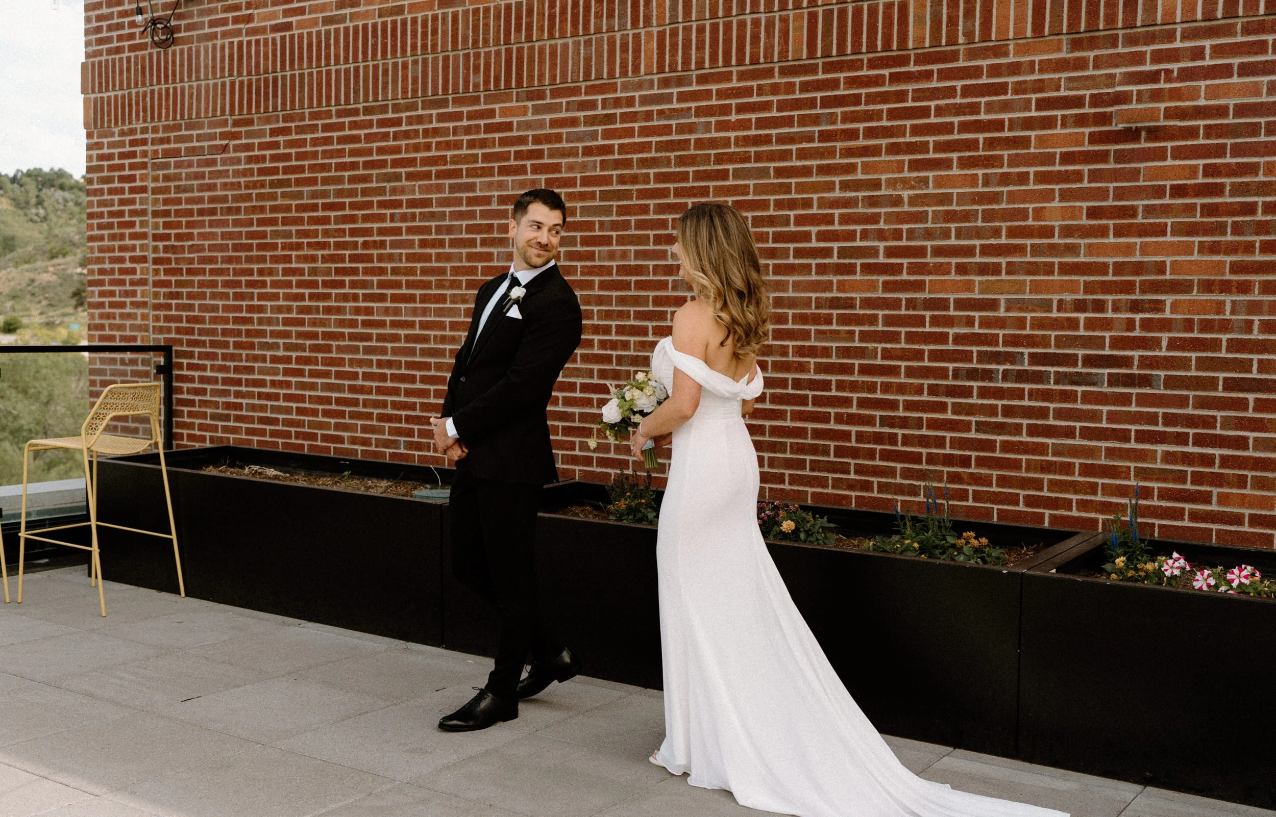 Groom turning around during first look on wedding day at The Eddy in Golden Colorado