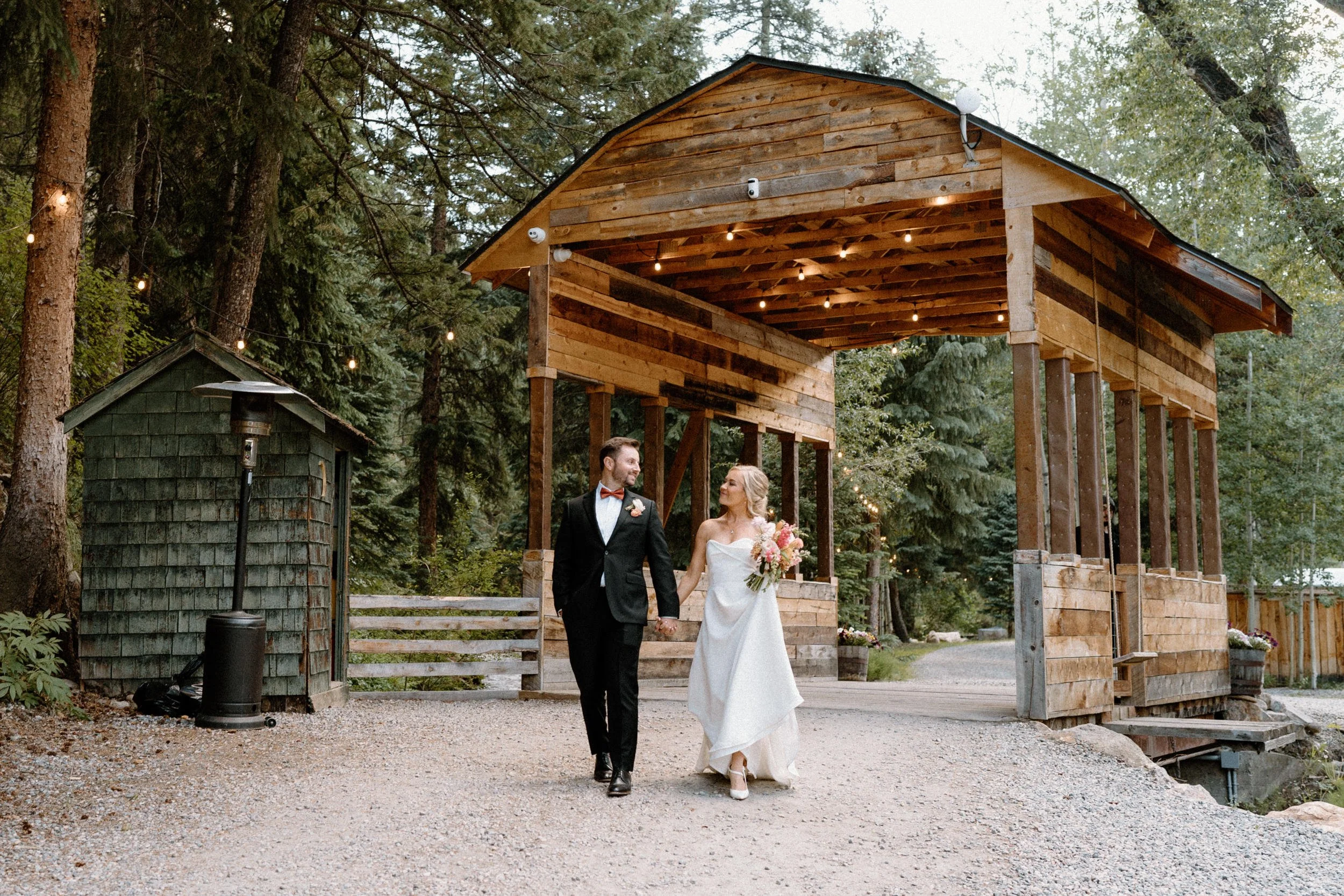 Bride and groom walking away from a bridge at Blackstone Rivers Ranch