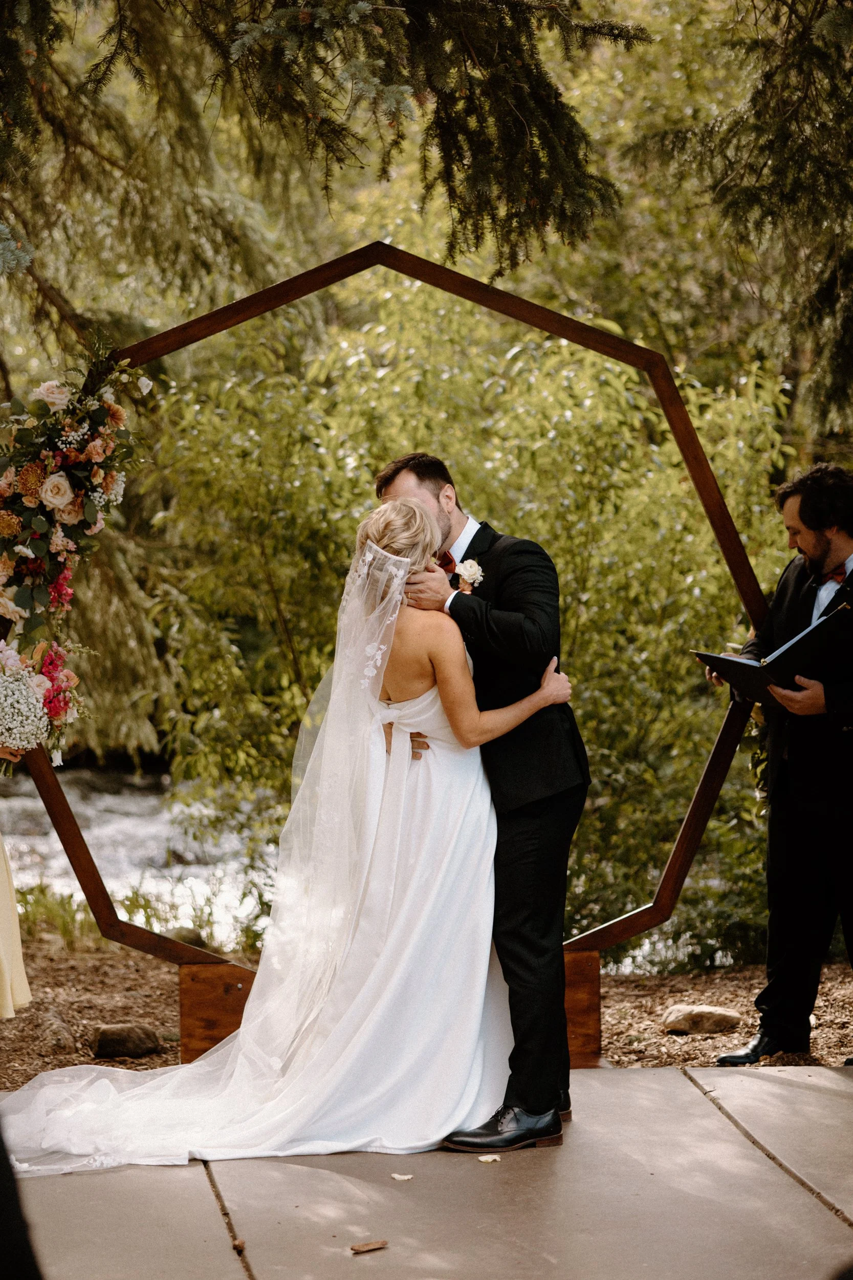 Bride and groom kissing during ceremony on wedding day at Blackstone Rivers Ranch