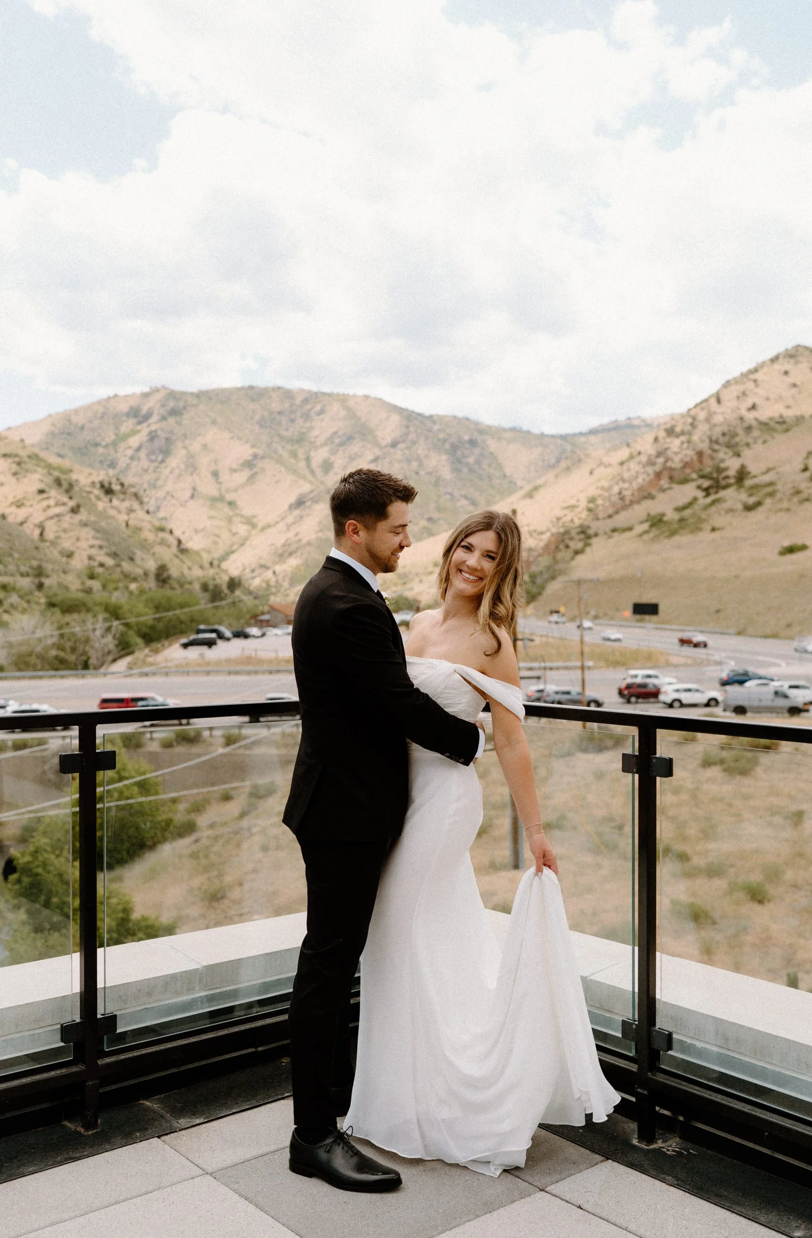 Bride and groom hugging on a balcony at The Eddy in Golden Colorado on wedding day