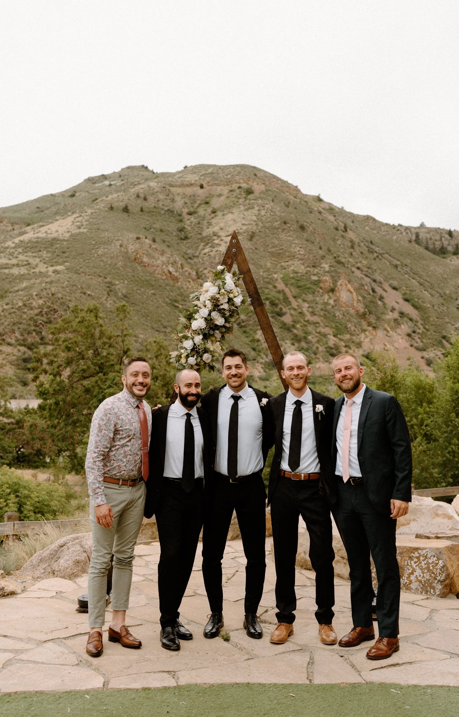 Groom and groomsmen smiling during a wedding at The Eddy in Golden Colorado