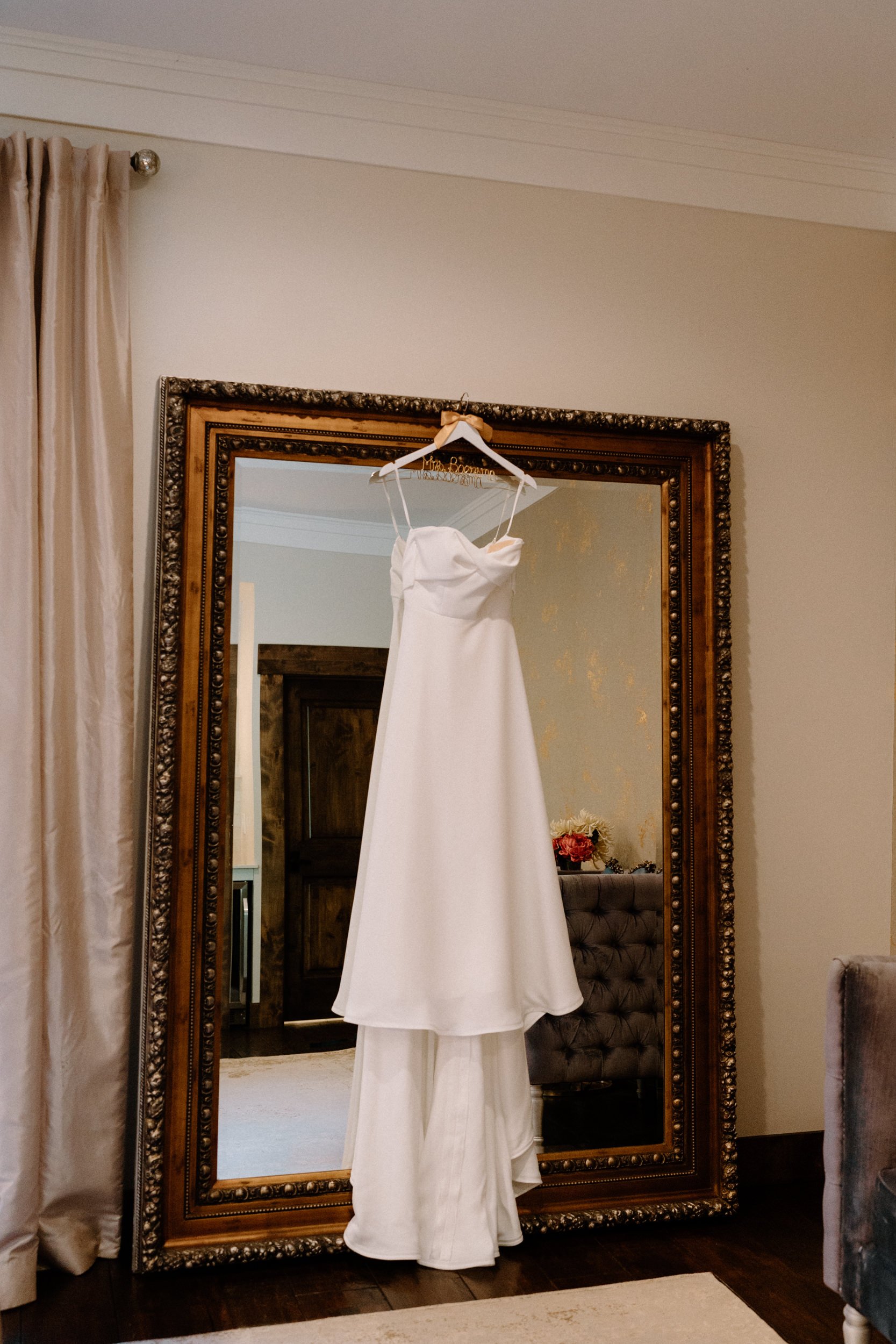 Wedding dress hanging on mirror from a wedding at Blackstone Rivers Ranch
