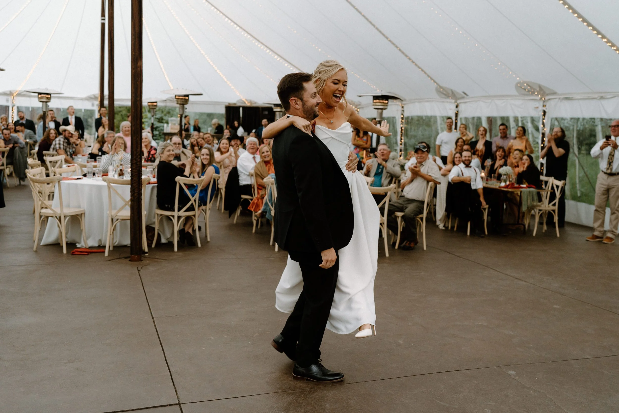Groom spinning bride on dance floor at Blackstone Rivers Ranch