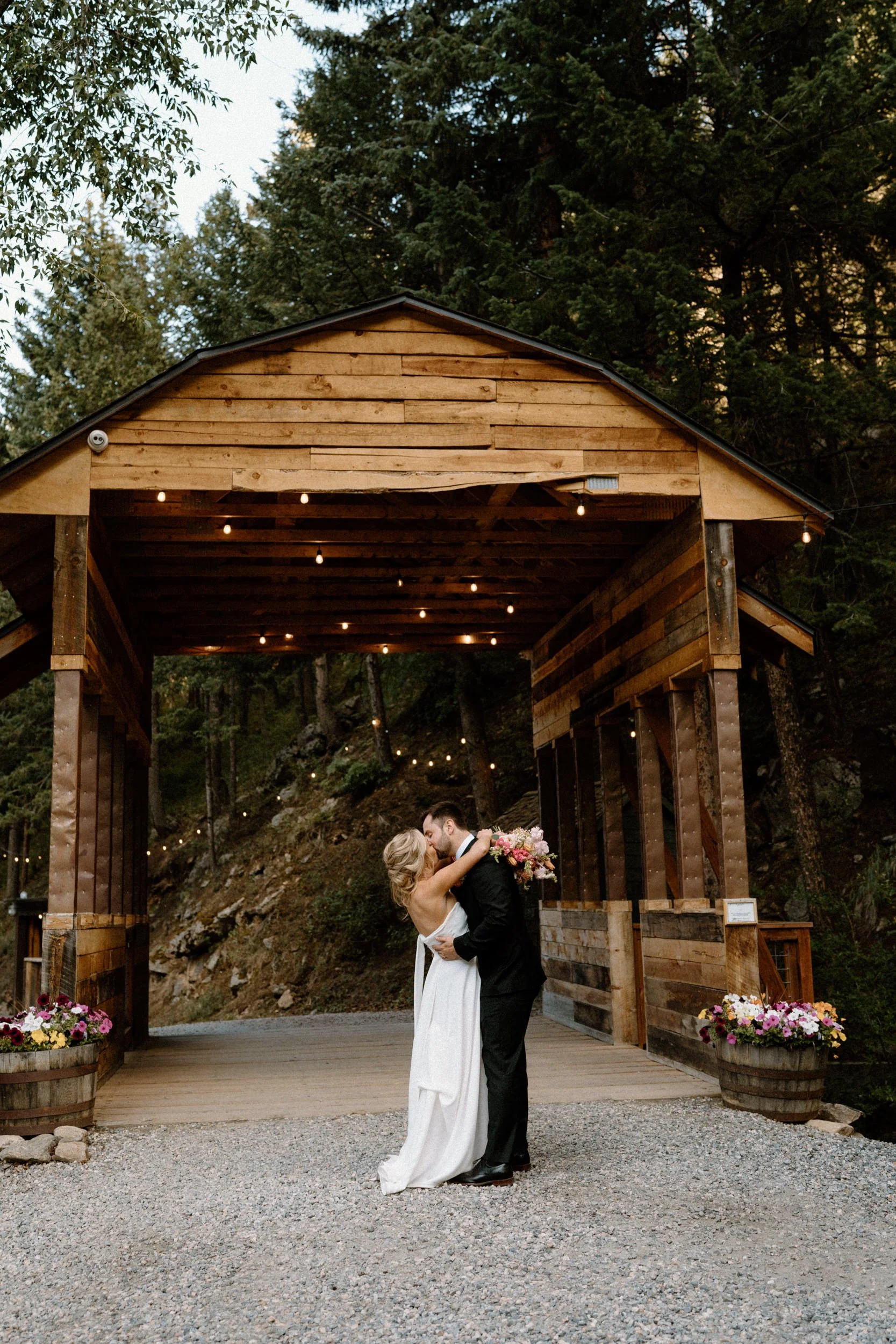 Bride and groom kissing on a path at Blackstone Rivers Ranch