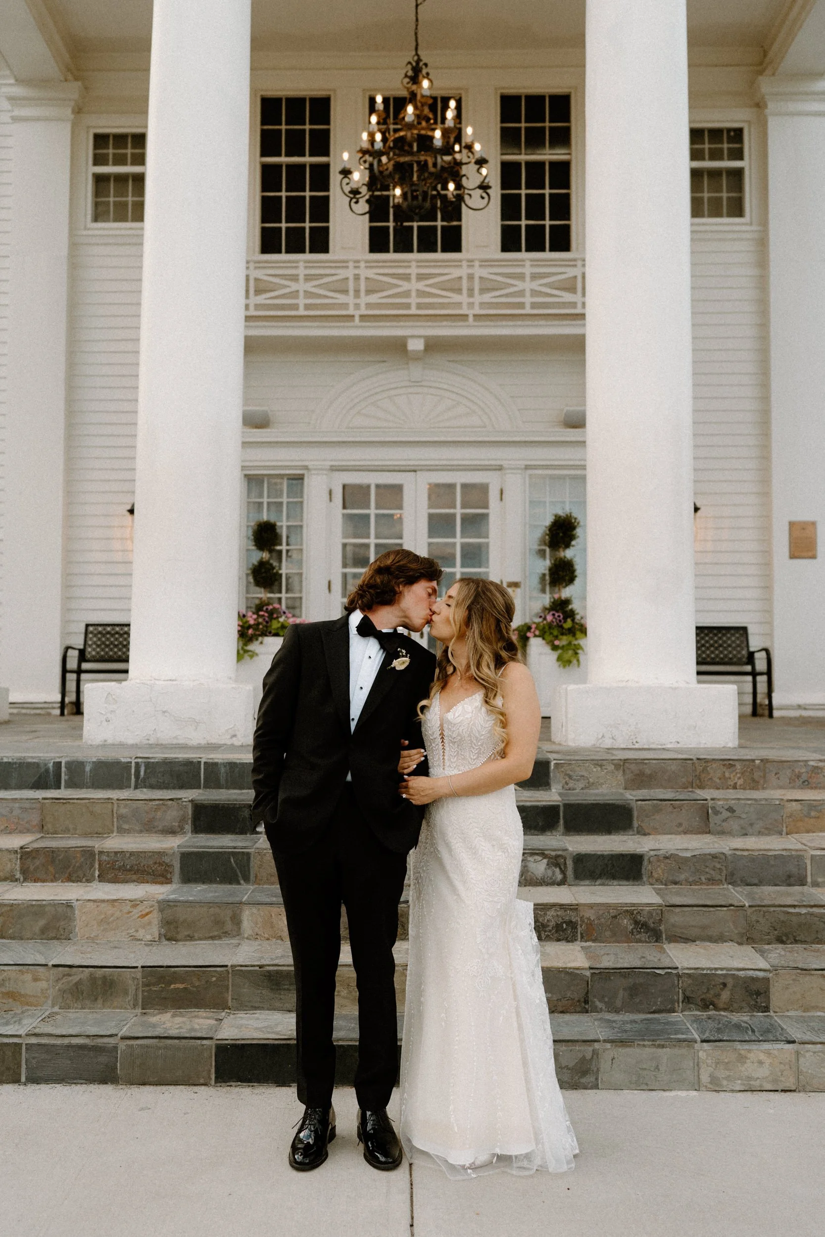Bride and groom kissing at The Manor House on wedding day