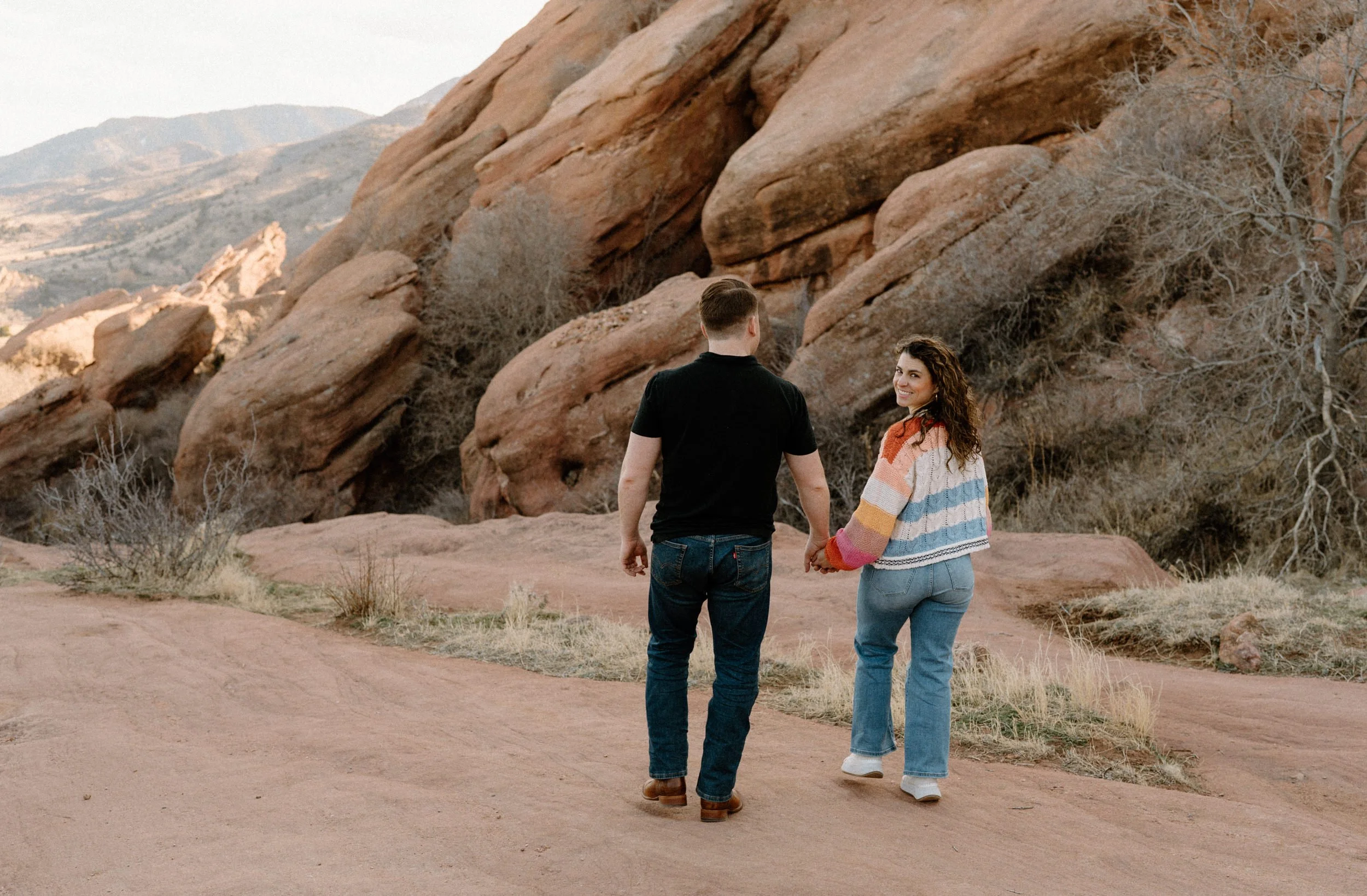Couple walking in Red Rocks during an engagement session