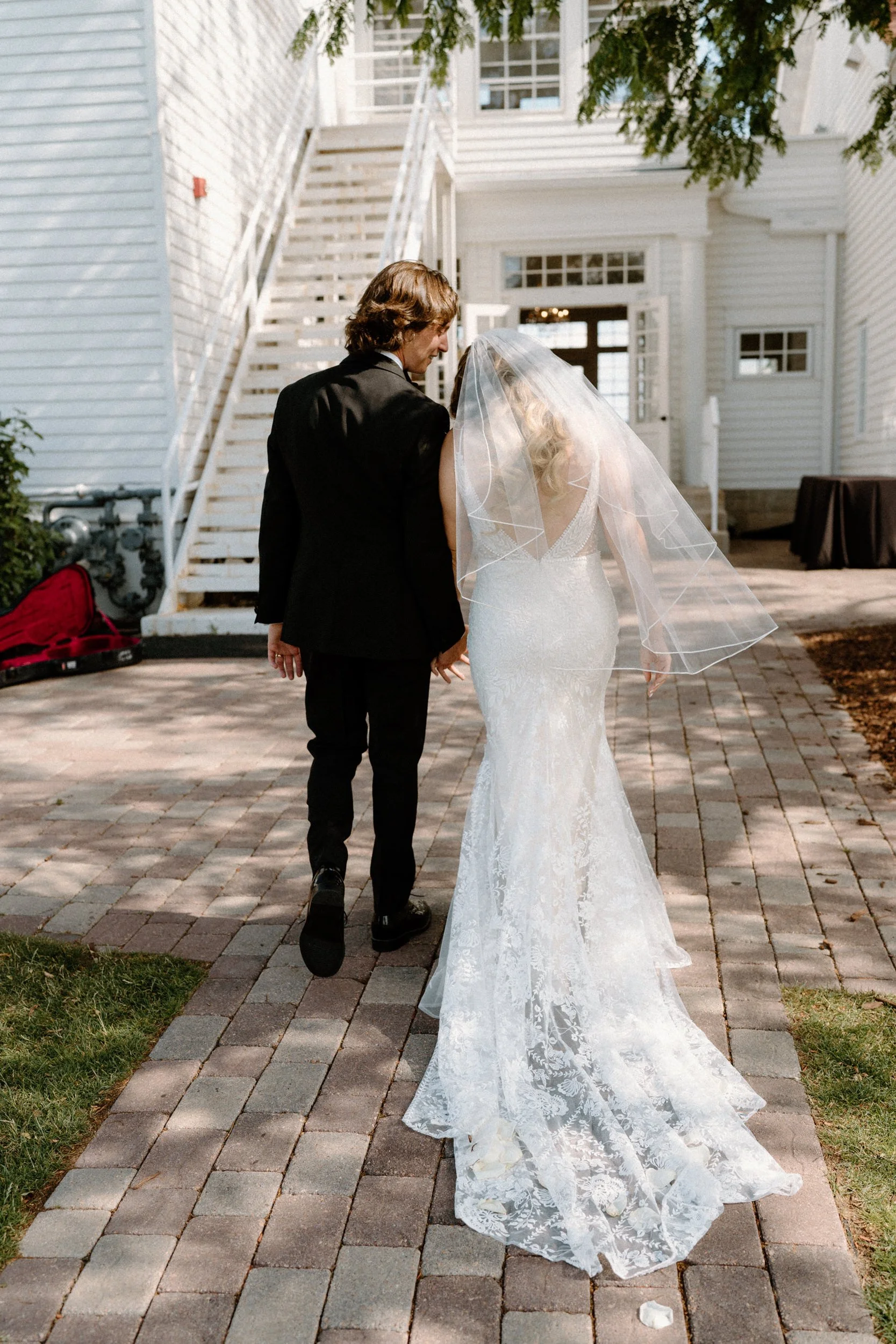 Bride and groom walking away from ceremony on wedding day at The Manor House