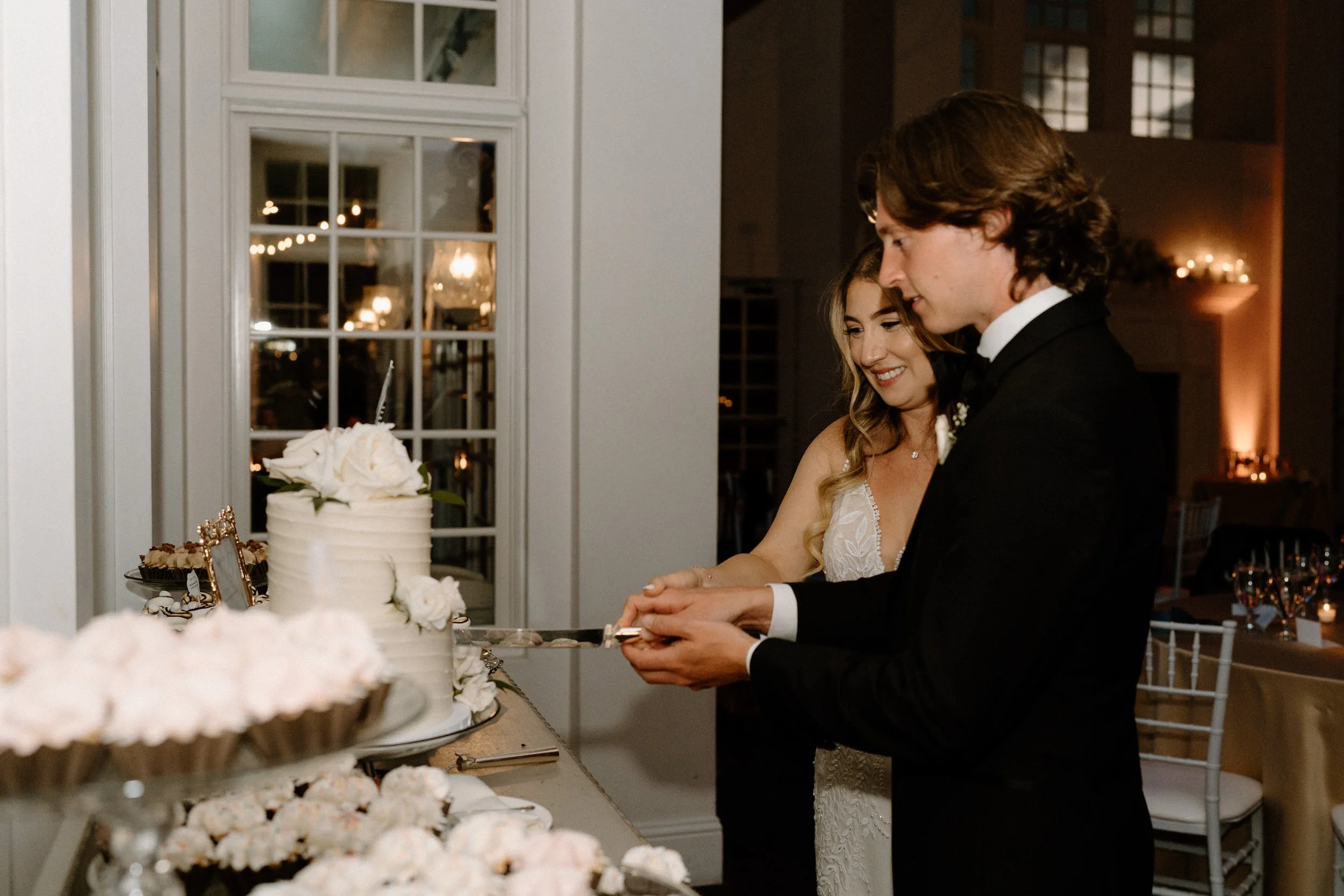 Bride and groom cutting their cake on wedding day at The Manor House