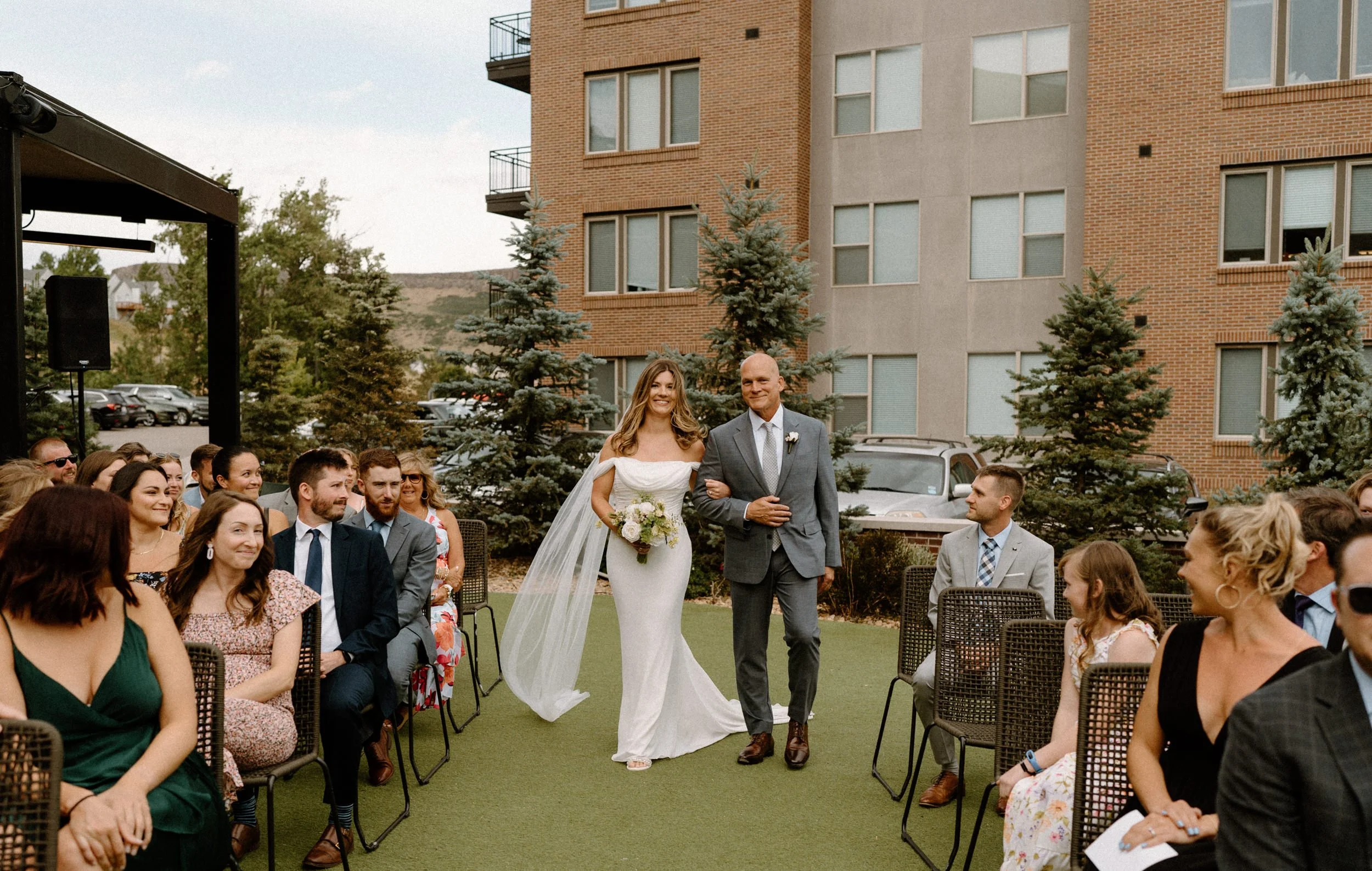 Bride and her dad walking down the aisle on wedding day at The Eddy in Golden Colorado