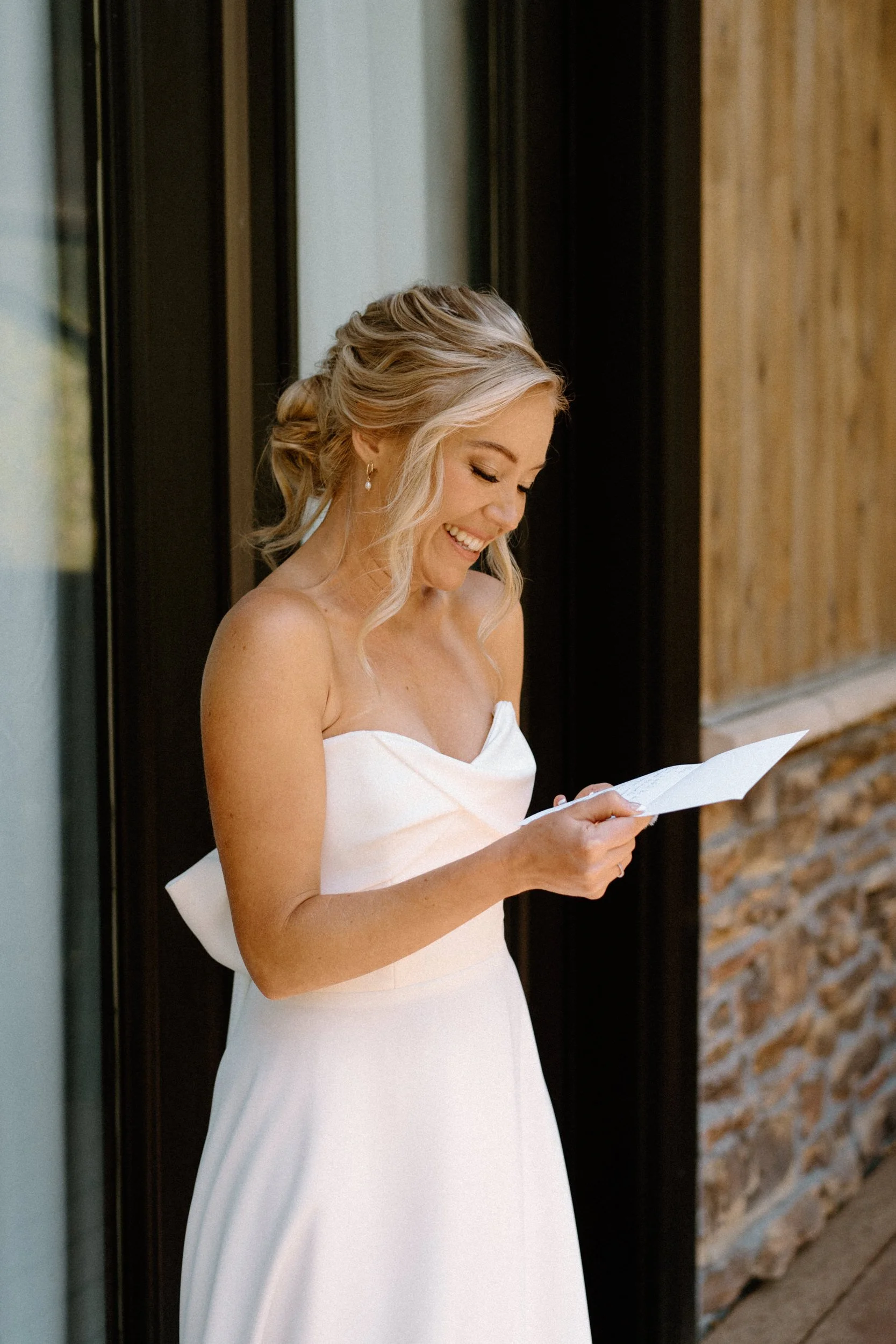 Bride reading a note on wedding day at Blackstone Rivers Ranch