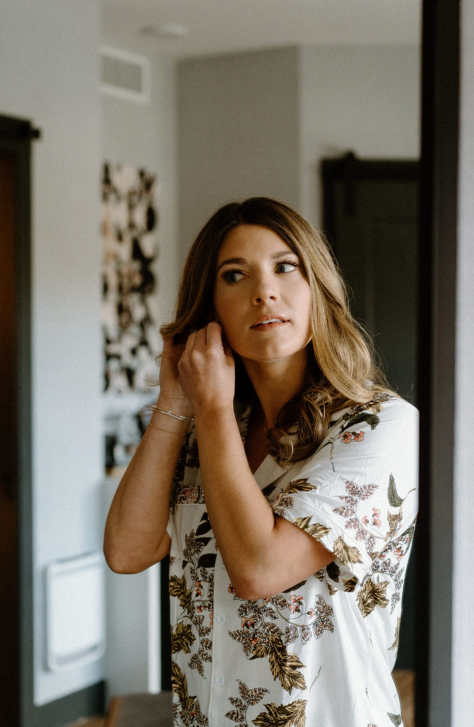 Bride putting on earring on wedding day at The Eddy in Golden Colorado
