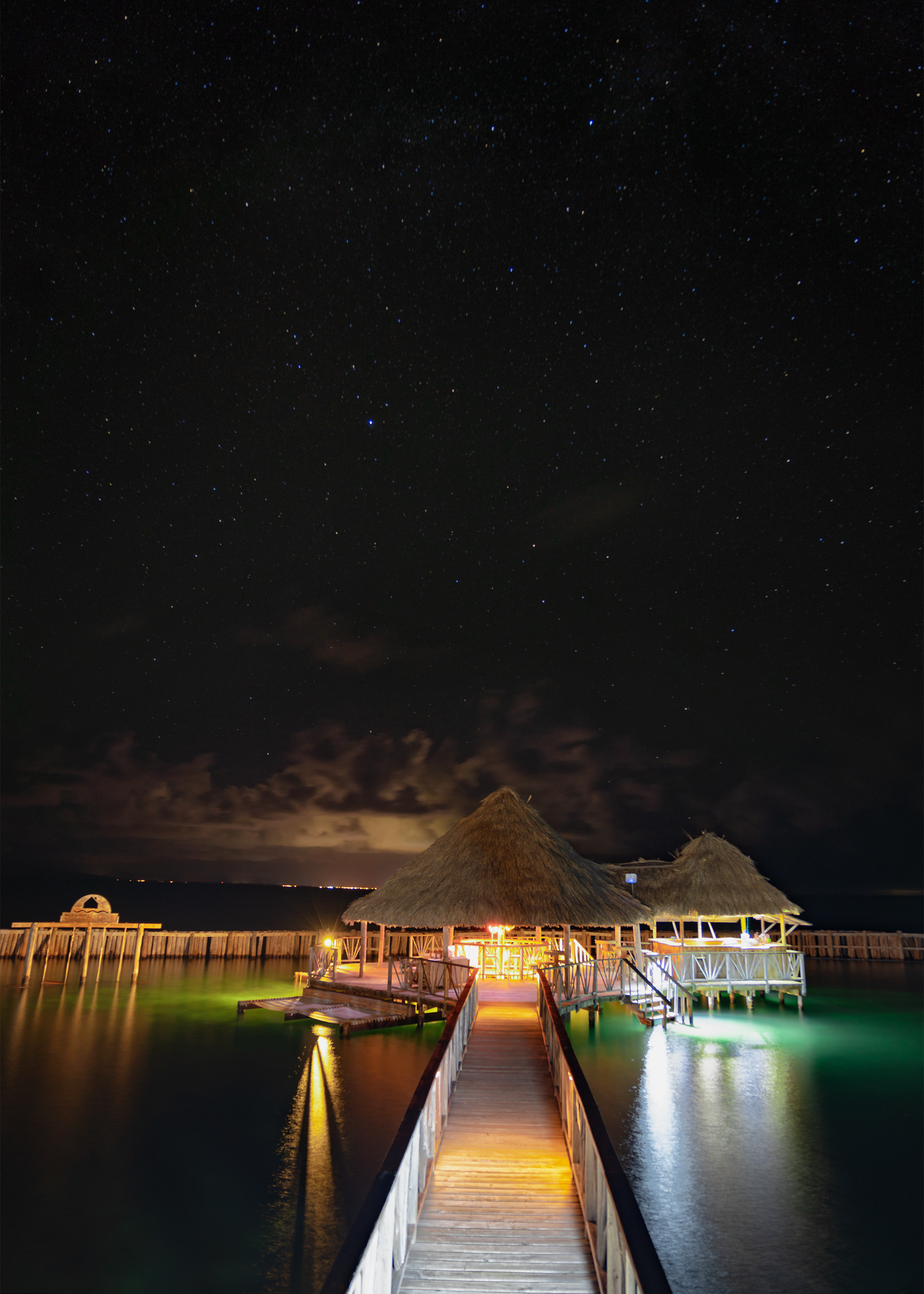Thatch Caye Starfish Bar at Night.png