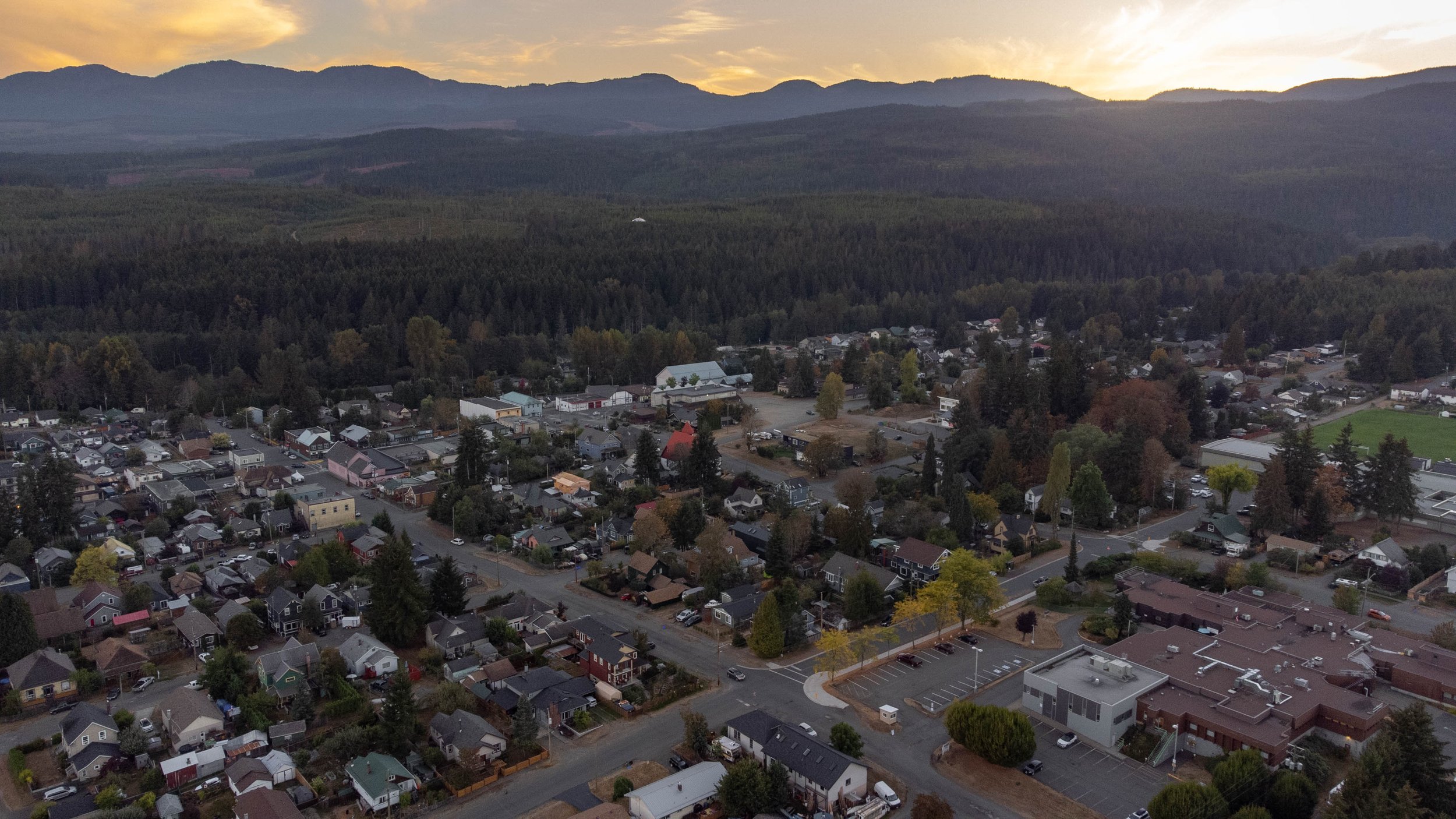  drone image looking over a small town at sunset 