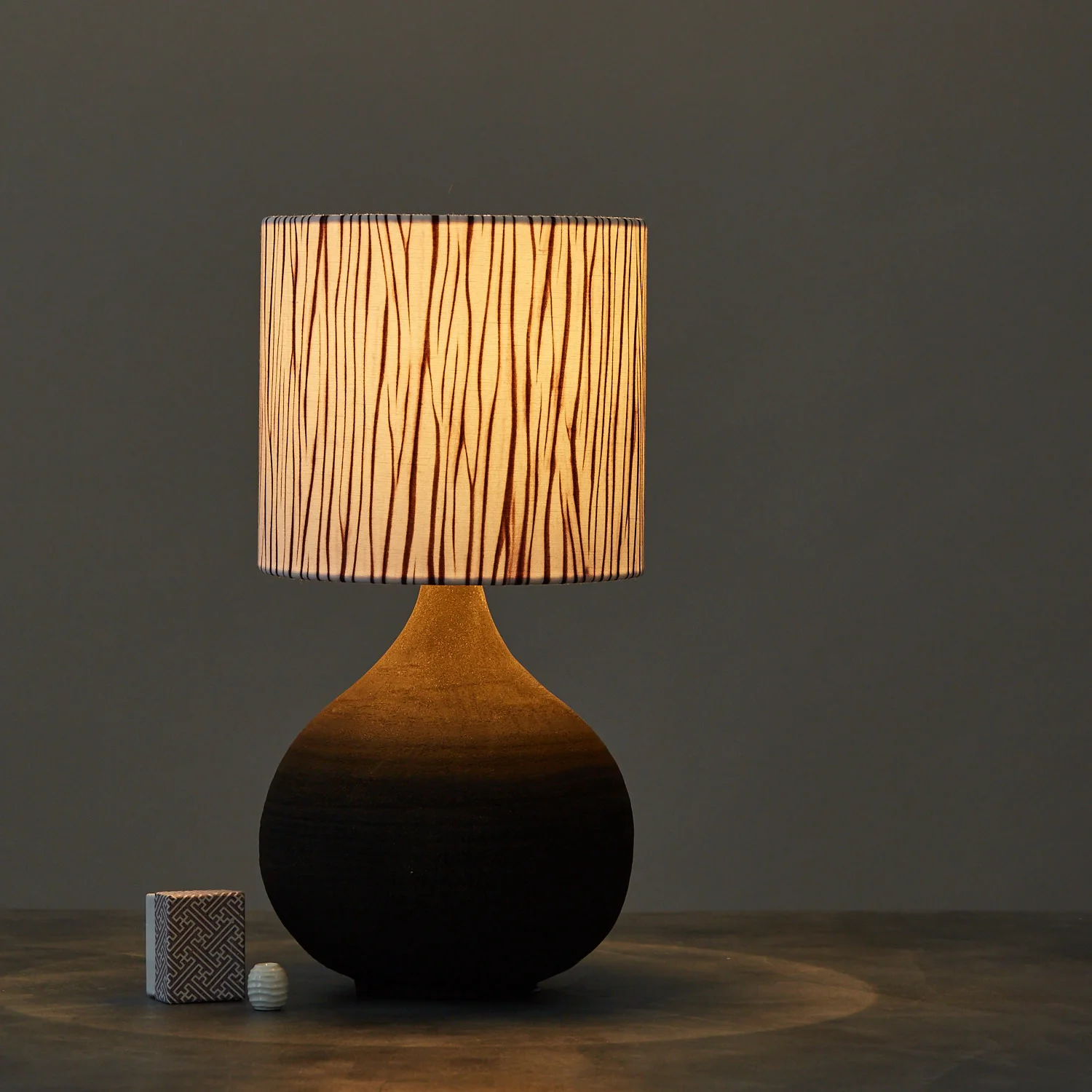 Purple arashi striped shibori lampshade - table lamp lit