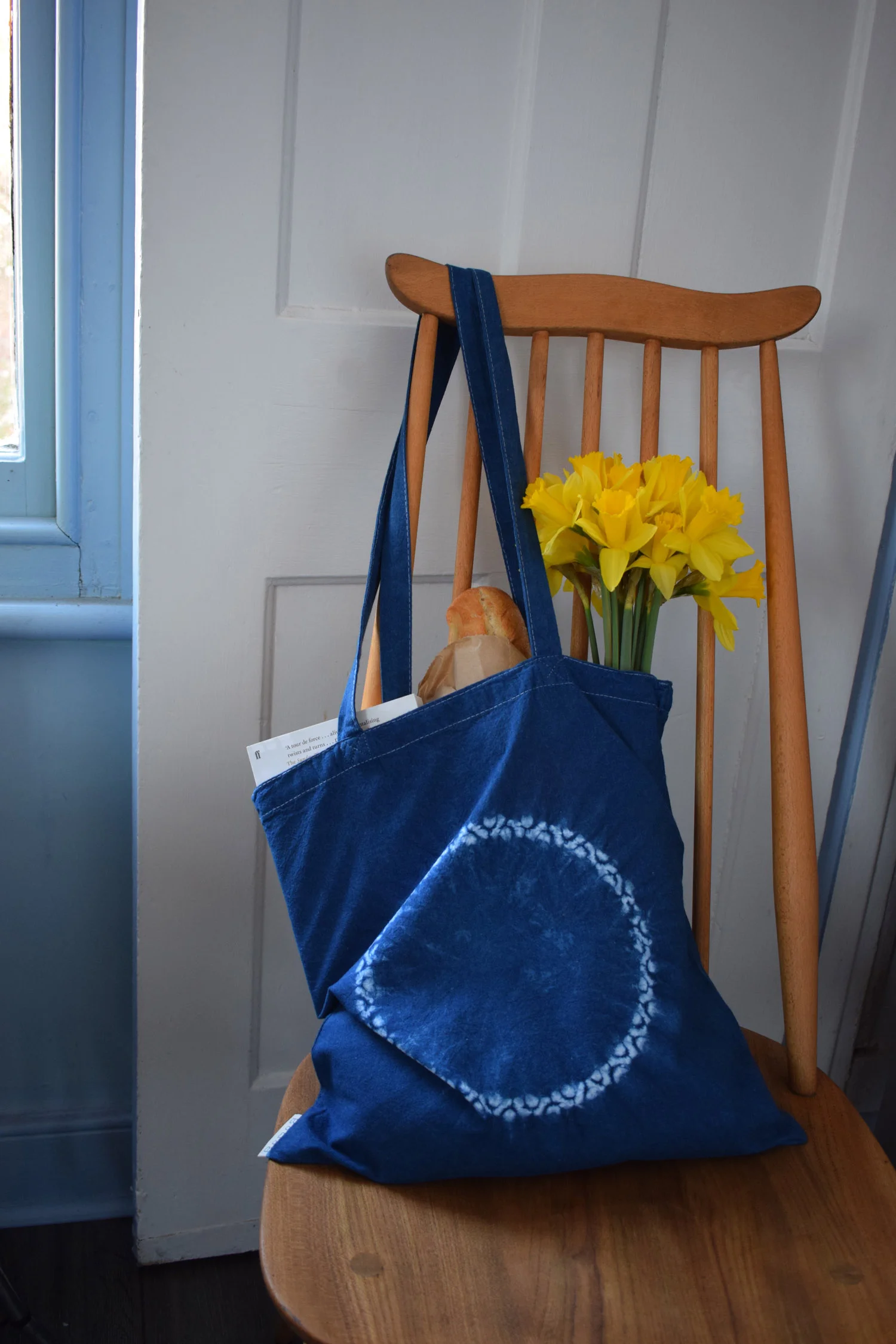 Romor Designs indigo tote - CROWN - KURUAN - on chair filled.jpg