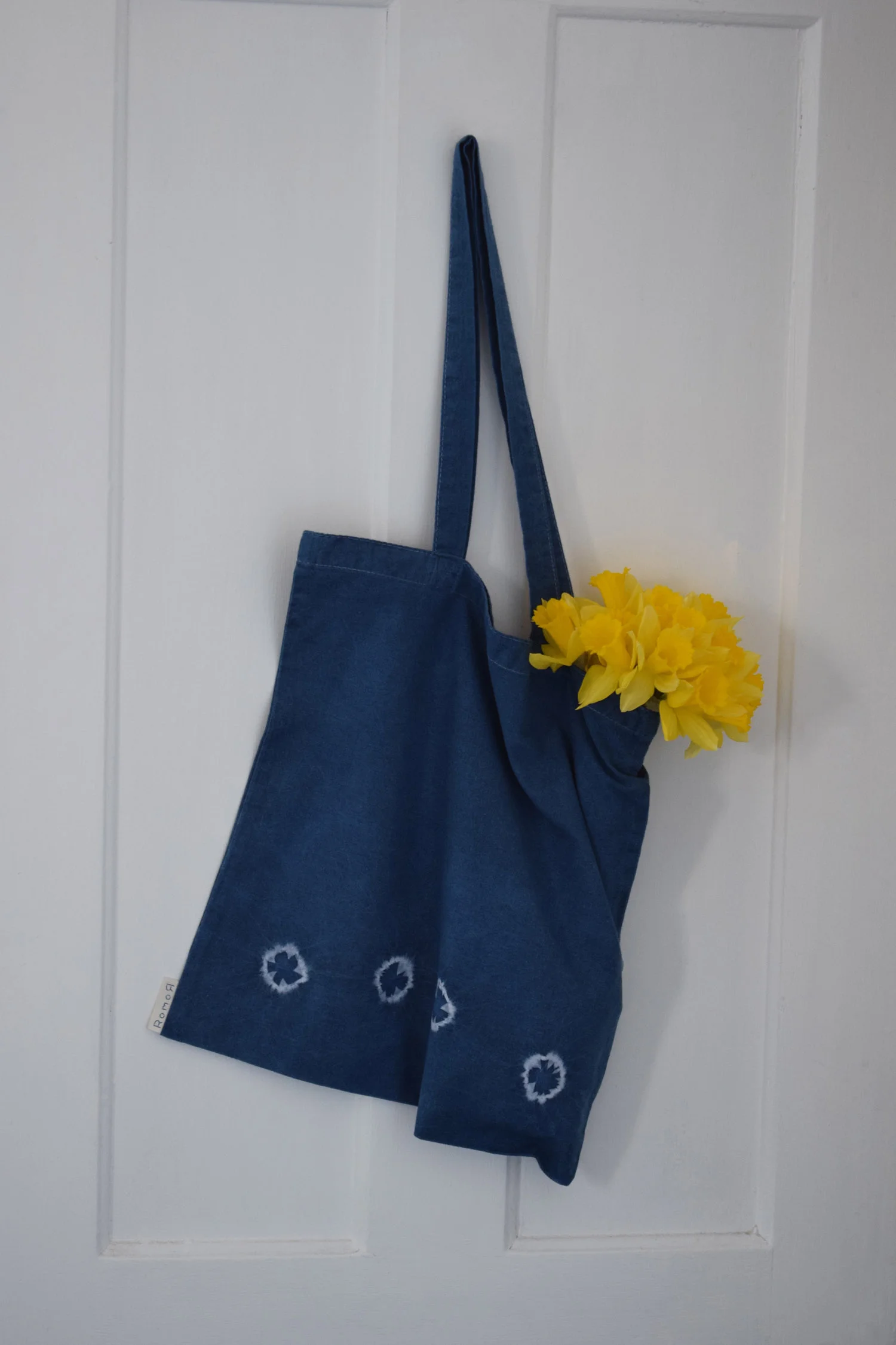 Romor Designs indigo tote - FLYING BIRDS - TOBUTORI - hanging on door.jpg