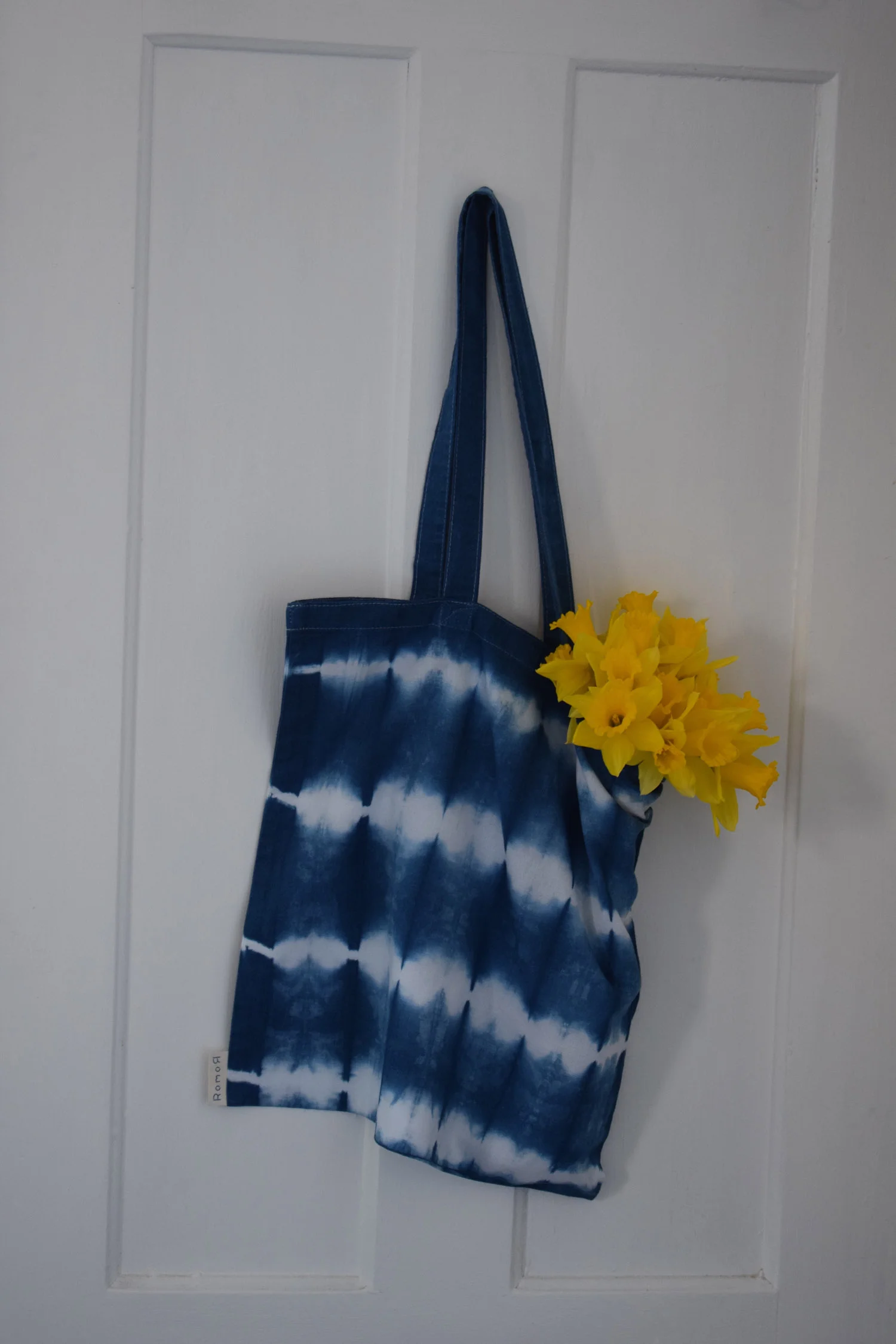 Romor Designs indigo tote - GRID - GURRIDO - hanging on door.jpg