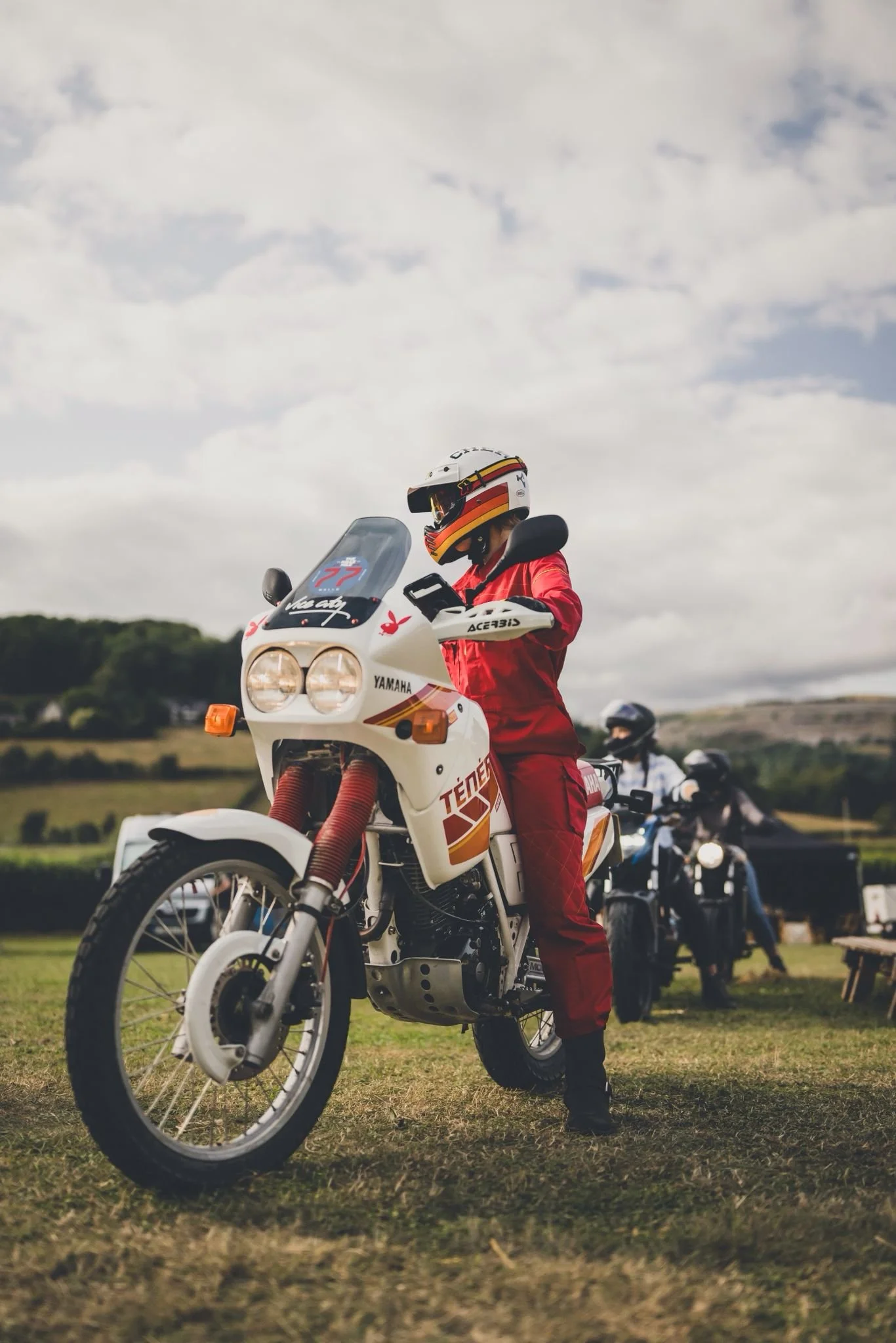 Woman on motorbike wearing red overalls