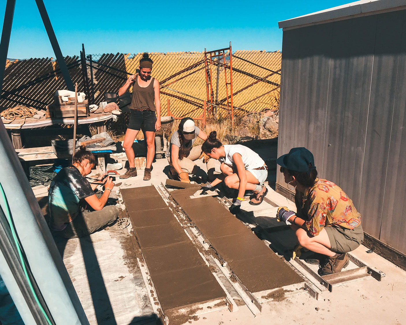 Workshoppers learning how to make concrete pavers