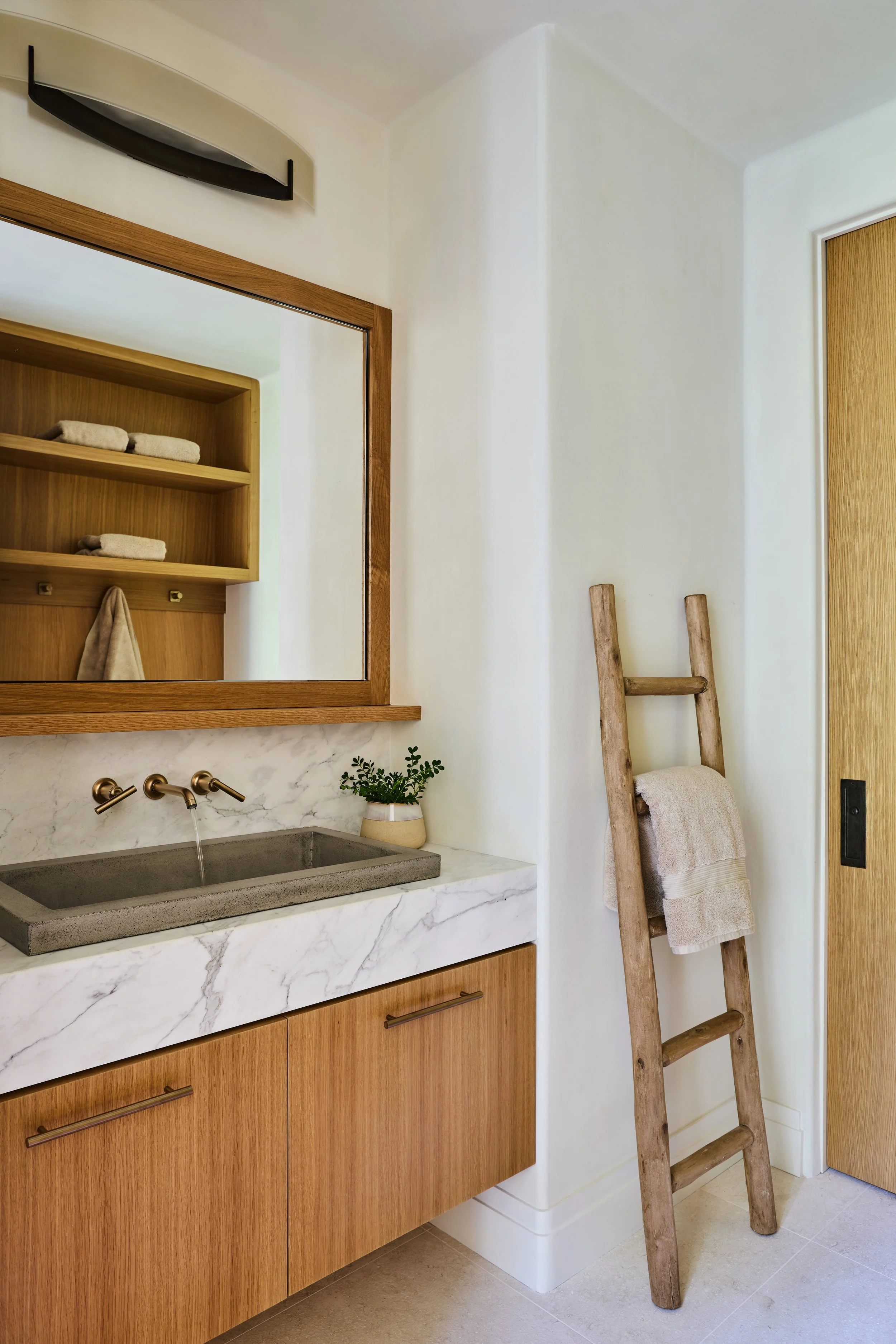  Bathroom zen. White oak, white porcelain tile, white thickened stone and light gray concrete sink. Rounded, softened wall corners give a feeling of relaxed comfort. 