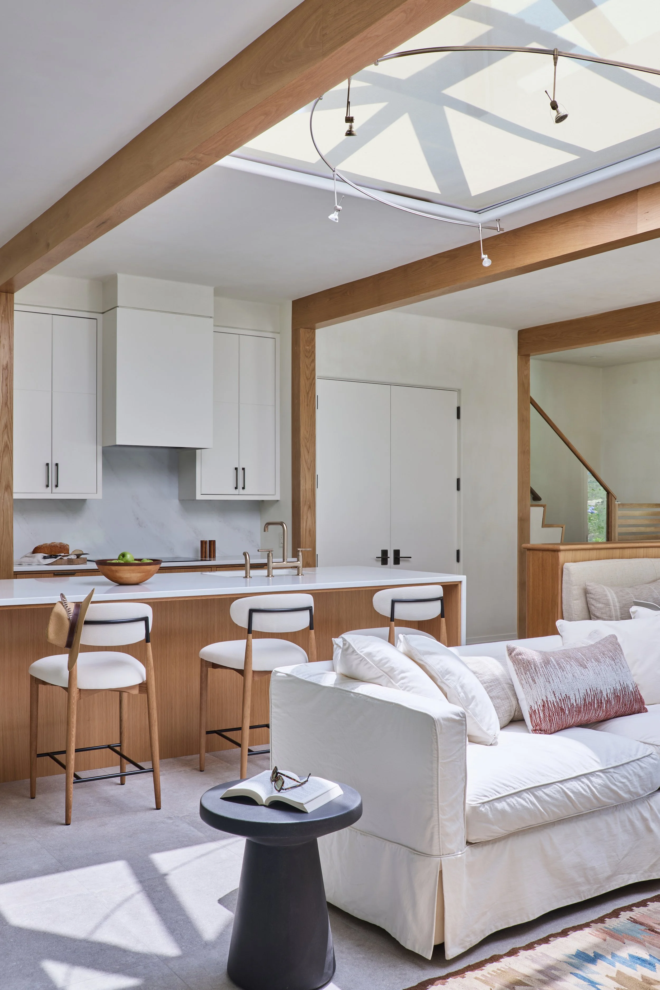  Lounge that is open to the porch has a large pyramidal skylight to bring in daylight to the north side of the house. A built-in motorized solar shade cuts down on glare. LED spot lights on a custom curved track focuses light down where it is needed.