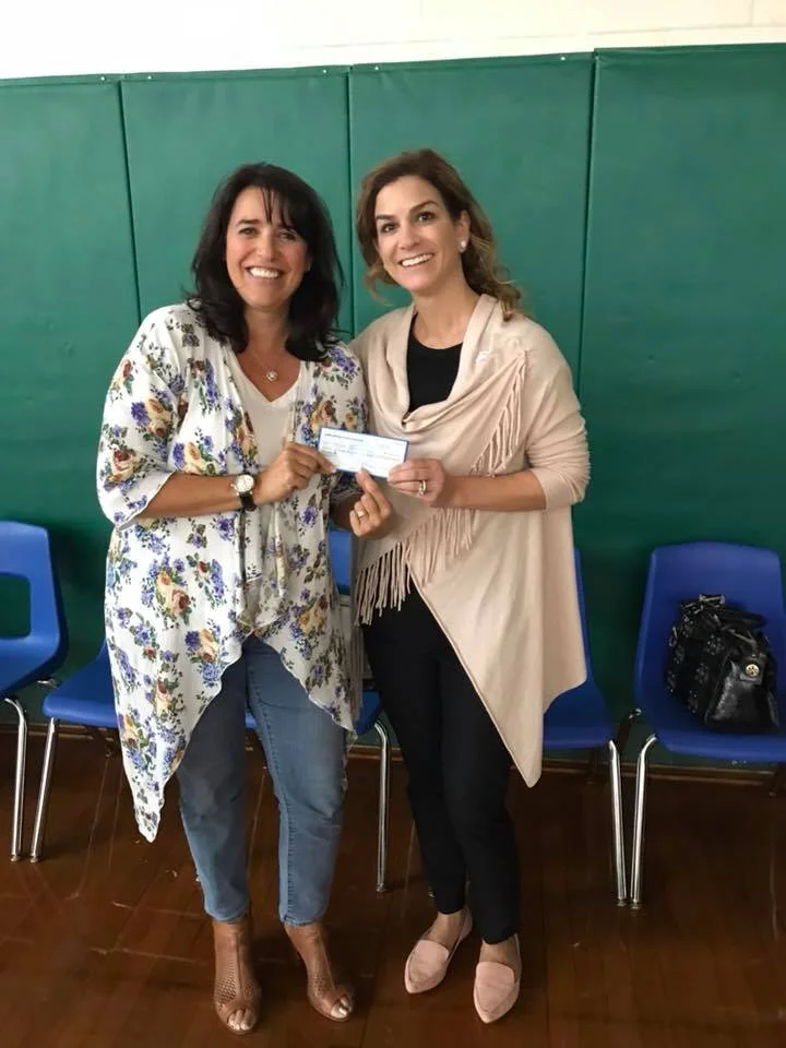 Michelle Eskow (AAKF Executive Director) presenting Laura Stanziano, and the Wayne Alliance with a check from the 7th annual poker tournament in honor of Albert Kayal, for next years event.