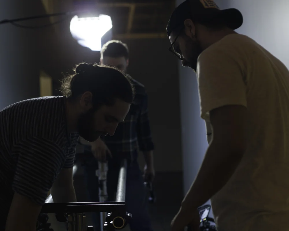 Sam, Tyler and Caleb setup rails for our dolly walking shot. (Photo: Ryan Kanaly)